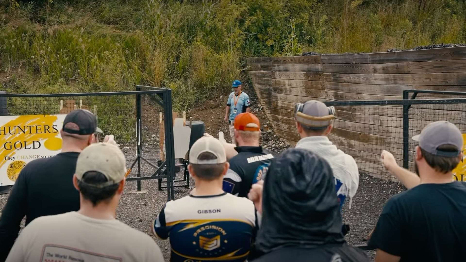 USPSA competitors listen during a stage briefing