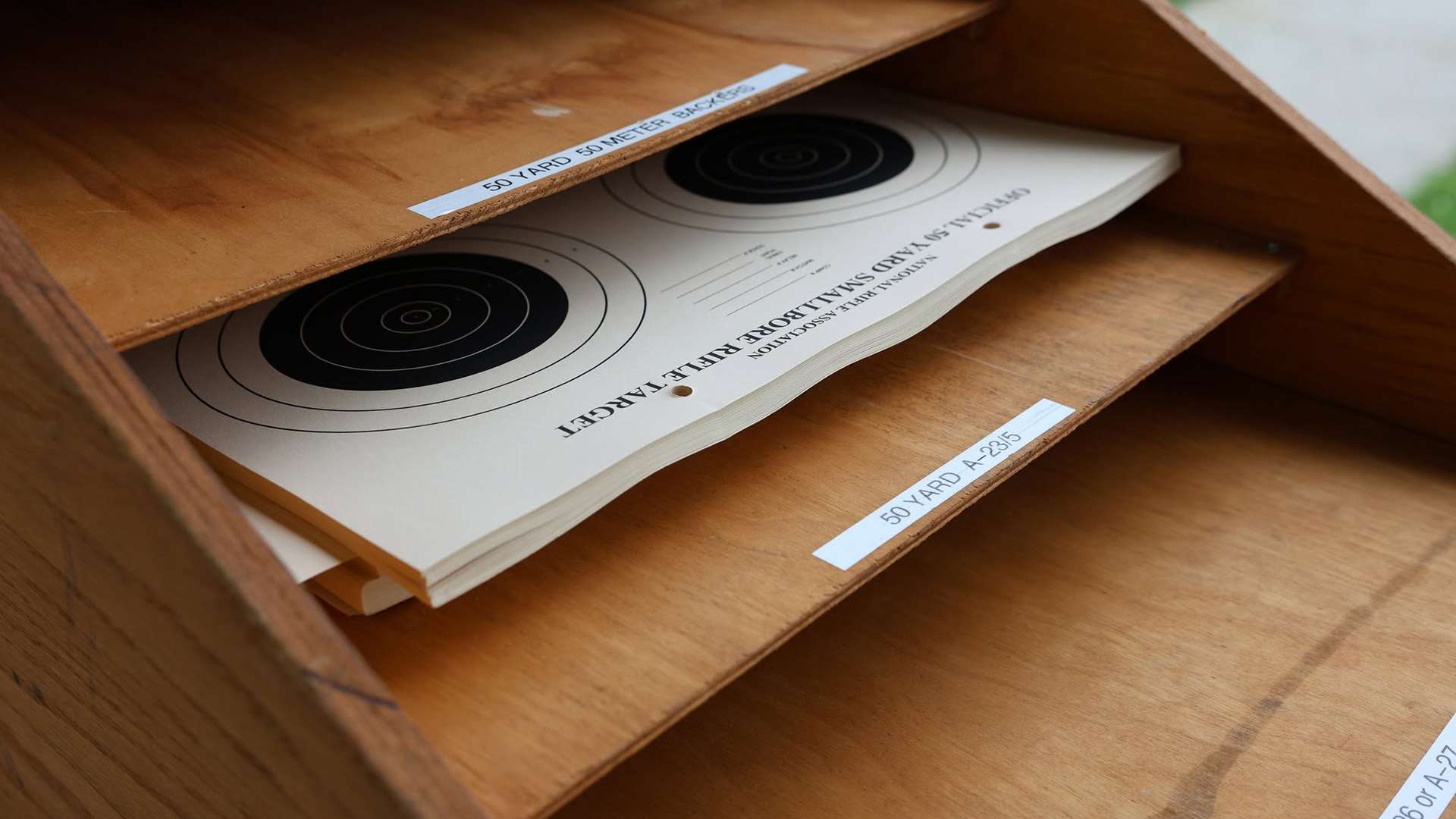 Official NRA A-23/5 50-yard smallbore rifle target showing five black bullseyes printed on heavy paper