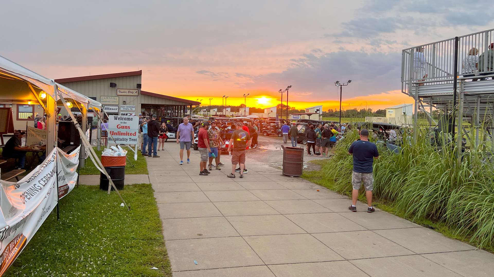 Competitors and spectators gather along the vendor row at the World Shooting and Recreational Complex as the sun sets over southern Illinois.