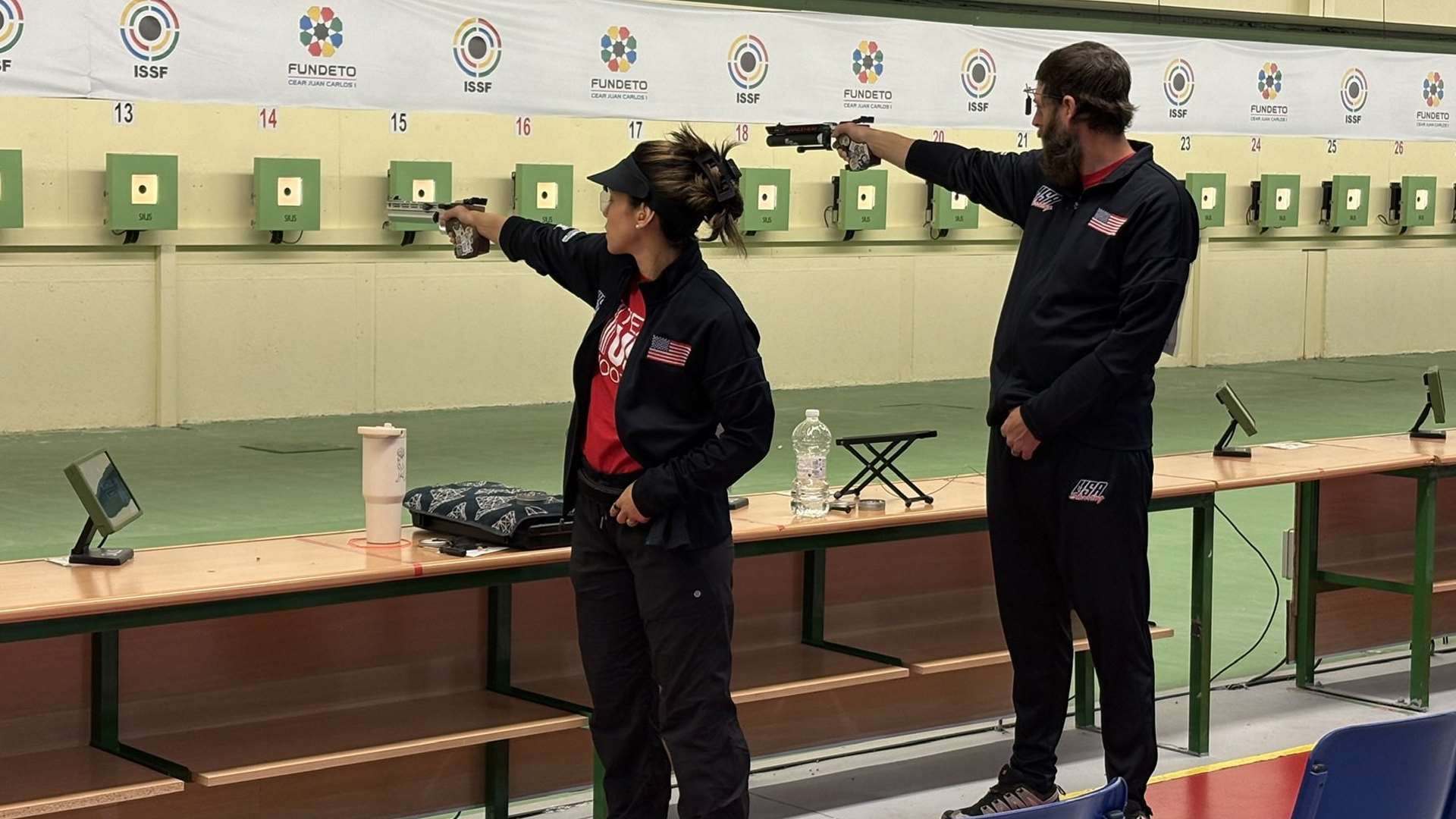 Nathalia Tobar and Nick Mowrer compete on the firing line in the 10m air pistol mixed team event at Las Gabias Shooting Center, Granada, Spain