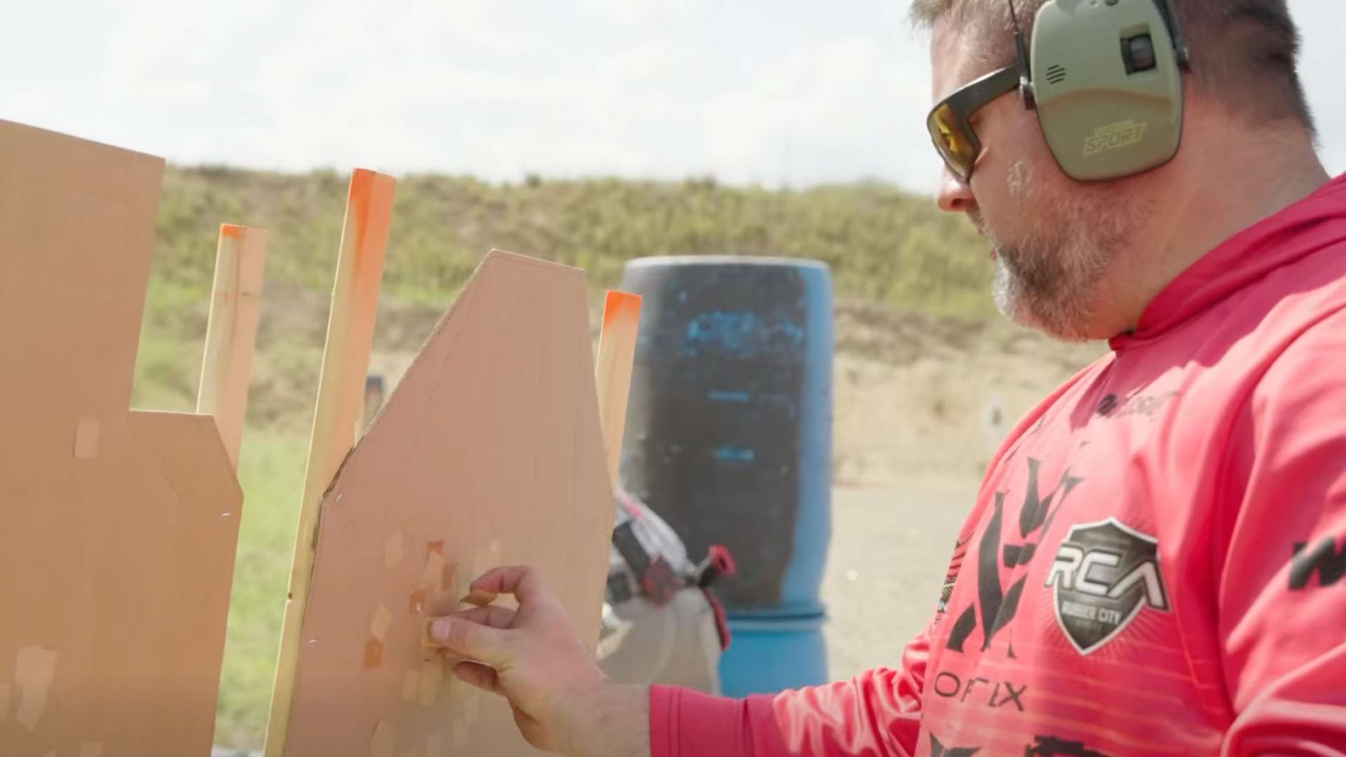 A shooter pastes cardboard targets at the 2023 USPSA Multigun Nationals in Minnesota