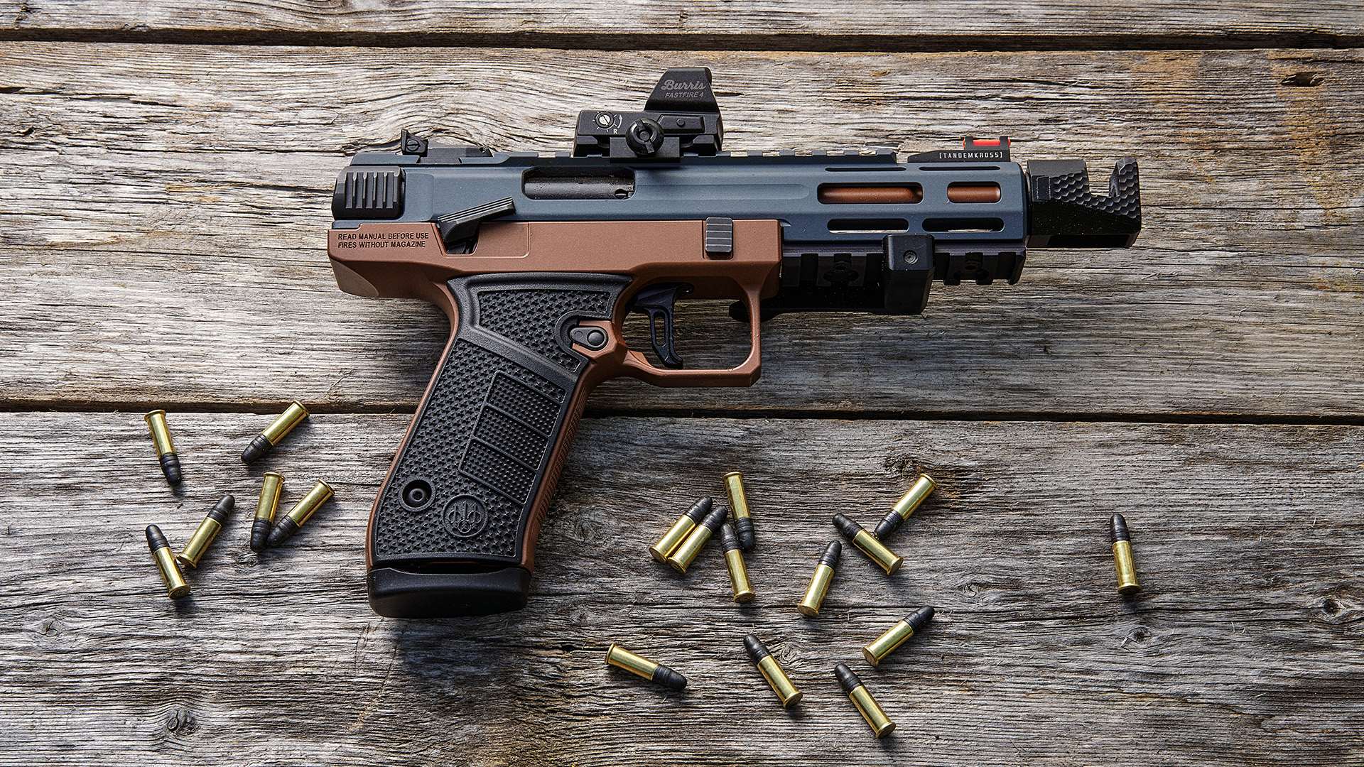 Beretta B22 Jaguar Metal Competition with Burris FastFire 4 red dot on weathered wood surrounded by .22 LR cartridges
