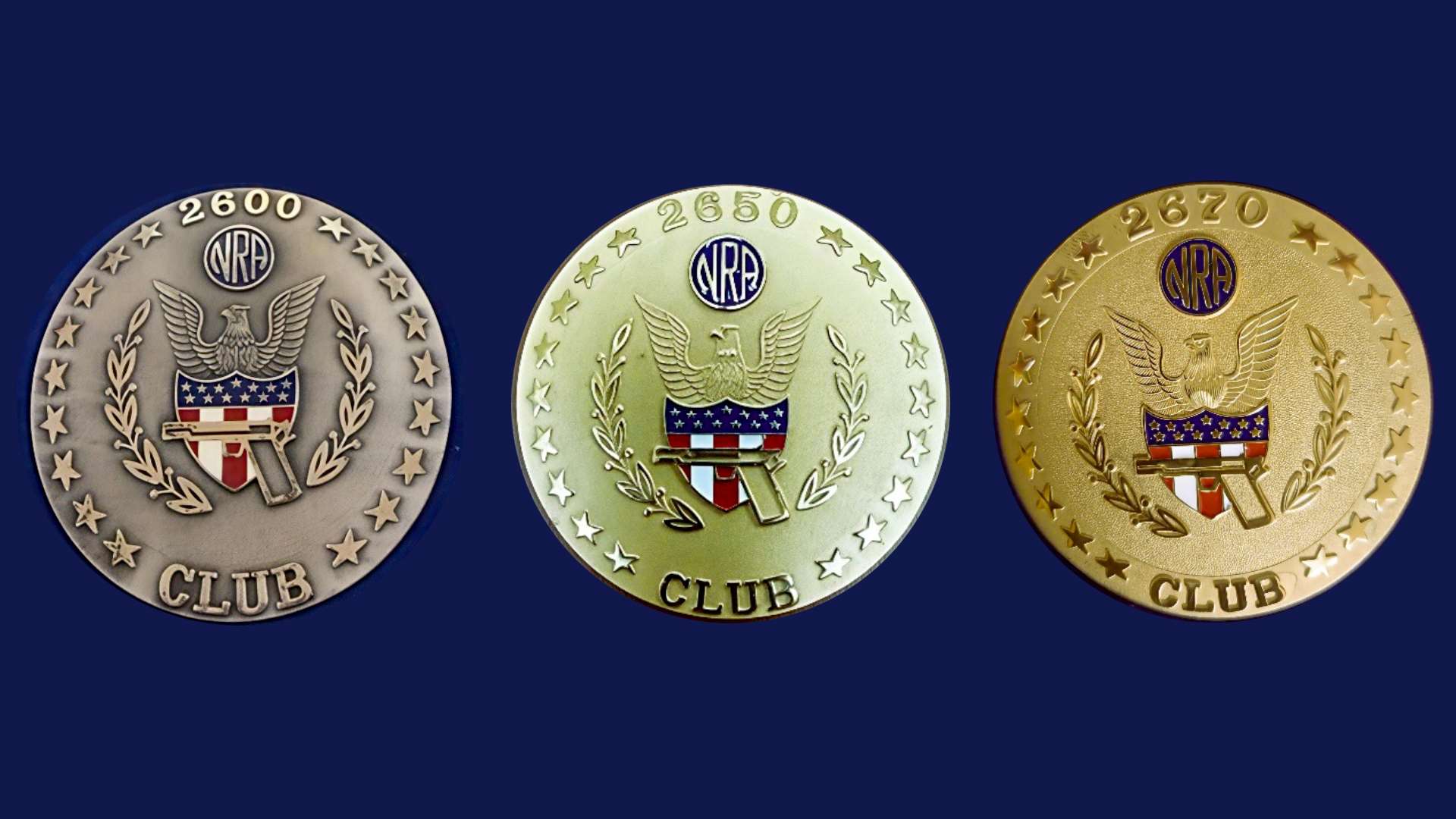 Three NRA Precision Pistol Honorary Club medallions arranged left to right: 2600 Club, 2650 Club and 2670 Club