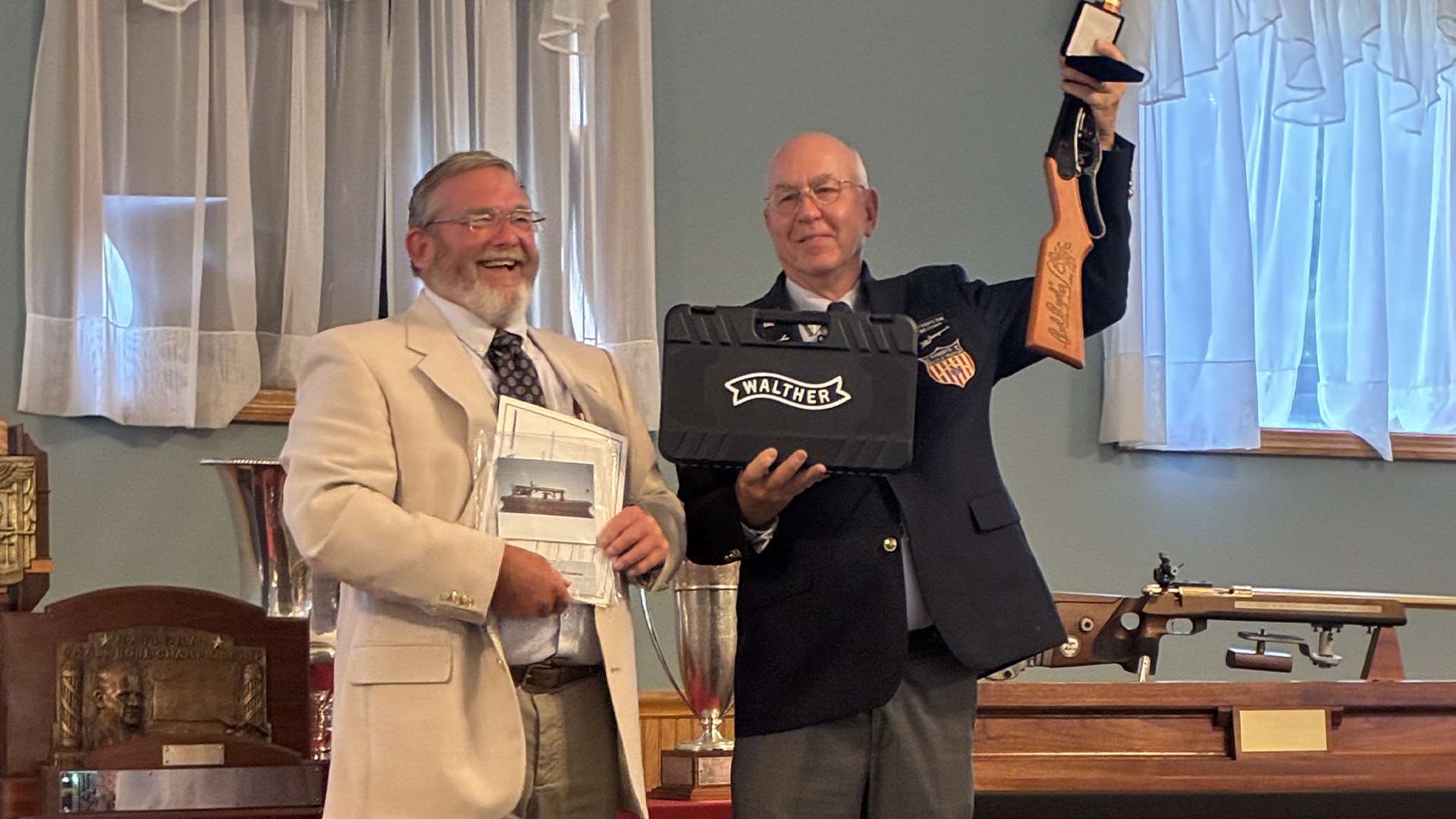 Chief Range Officer Clyde Furr handing the NRA Lones Wigger Iron Man Trophy to Mike O'Connor at the awards presentation