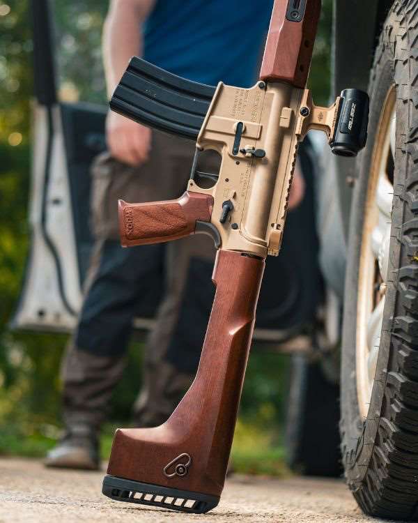 Walnut grain and machined aluminum hardware on the WOOX Vigilante Fixed Stock