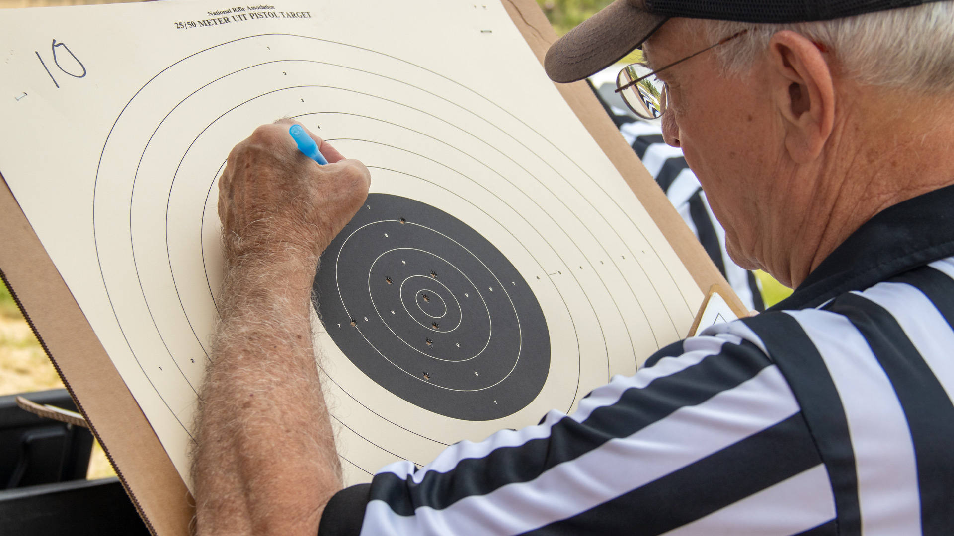 NRA referee scores bullseye pistol target