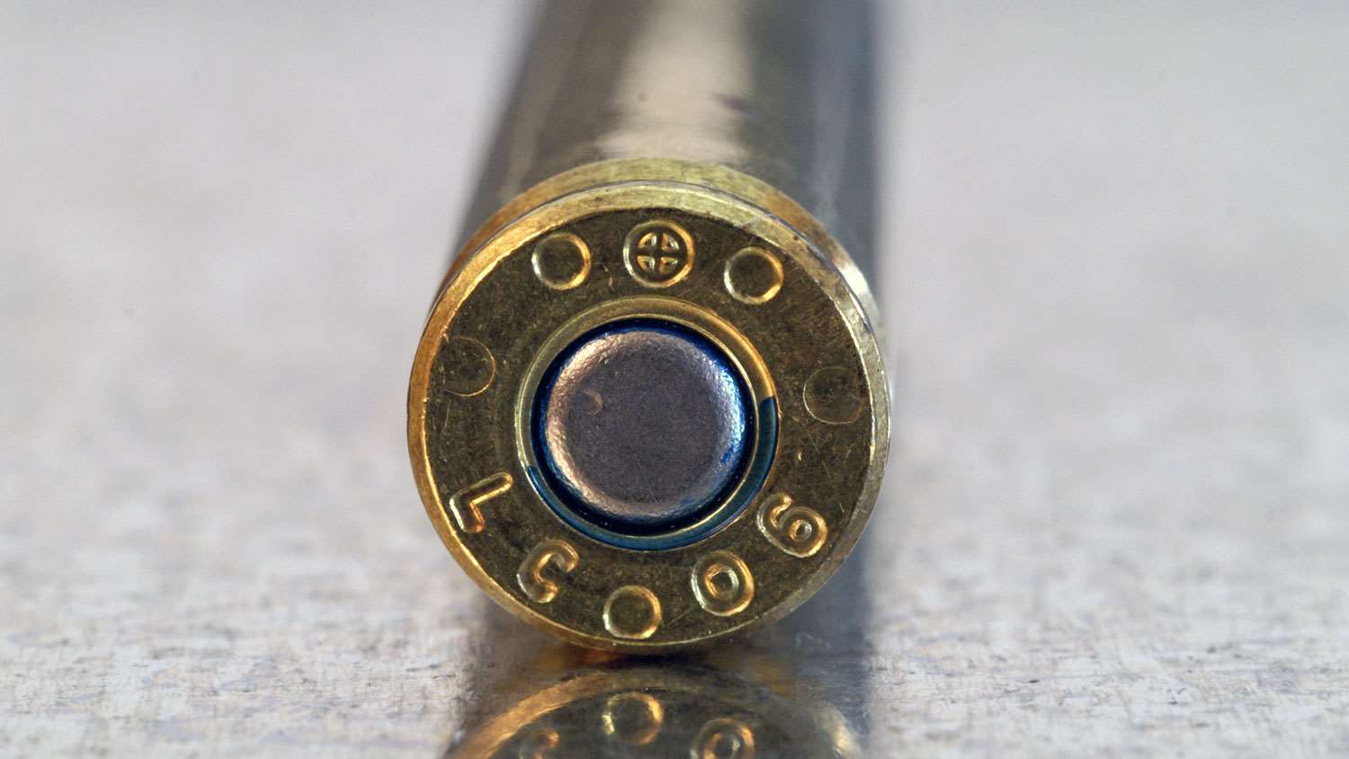 The cross-in-a-circle stamp identifies this as a genuine NATO-spec cartridge. It’s hot and getting hotter. Not  all “mil-spec” commercially available ammo is genuine NATO, but don’t risk it. It needs to be stamped “.223 Rem.” (Glen Zediker)