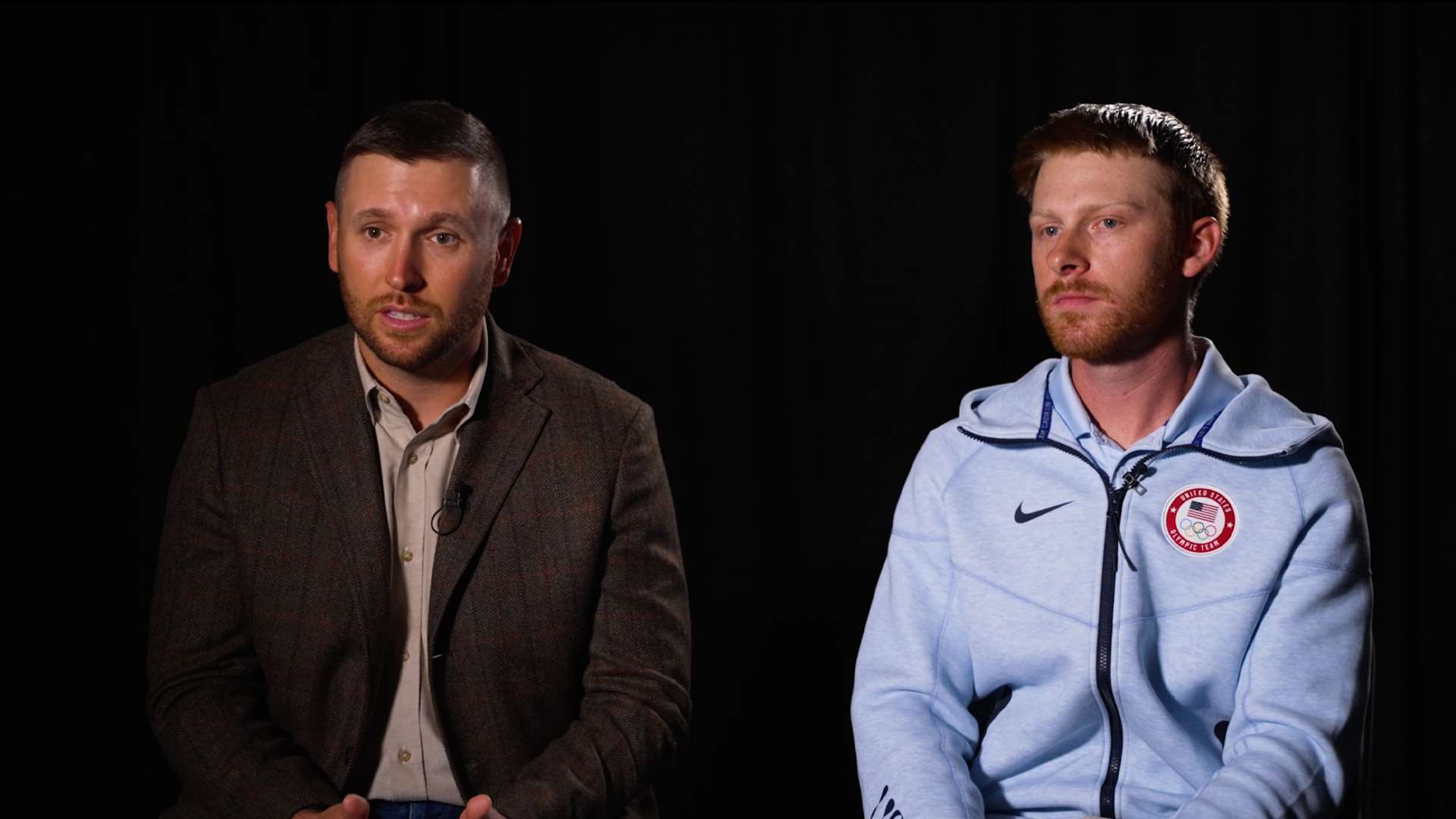 Vincent Hancock and Conner Prince seated side by side against a black backdrop during a video interview