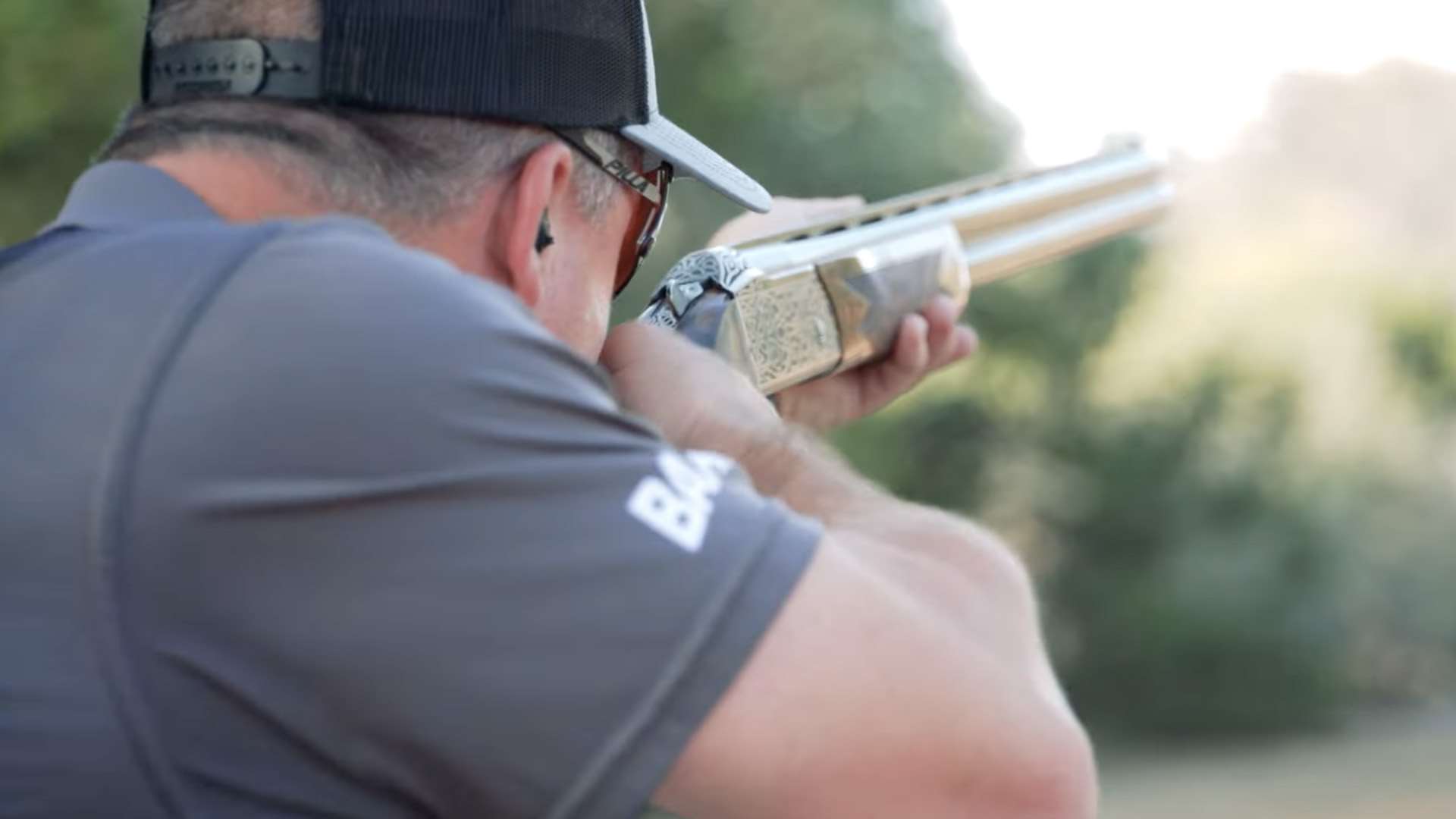 Sporting clays competitor shooting an engraved over-under shotgun at the NSCA National Sporting Clays Championship in San Antonio