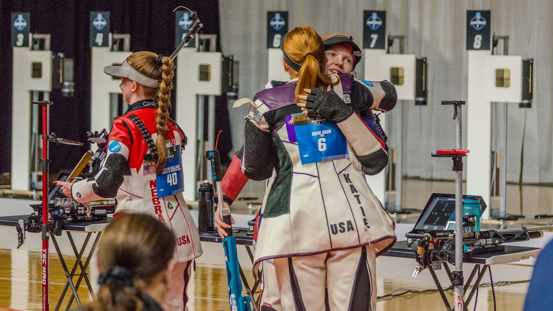 Katie Zaun and Audrey Gogniat embrace after 2026 NCAA rifle championship air rifle final