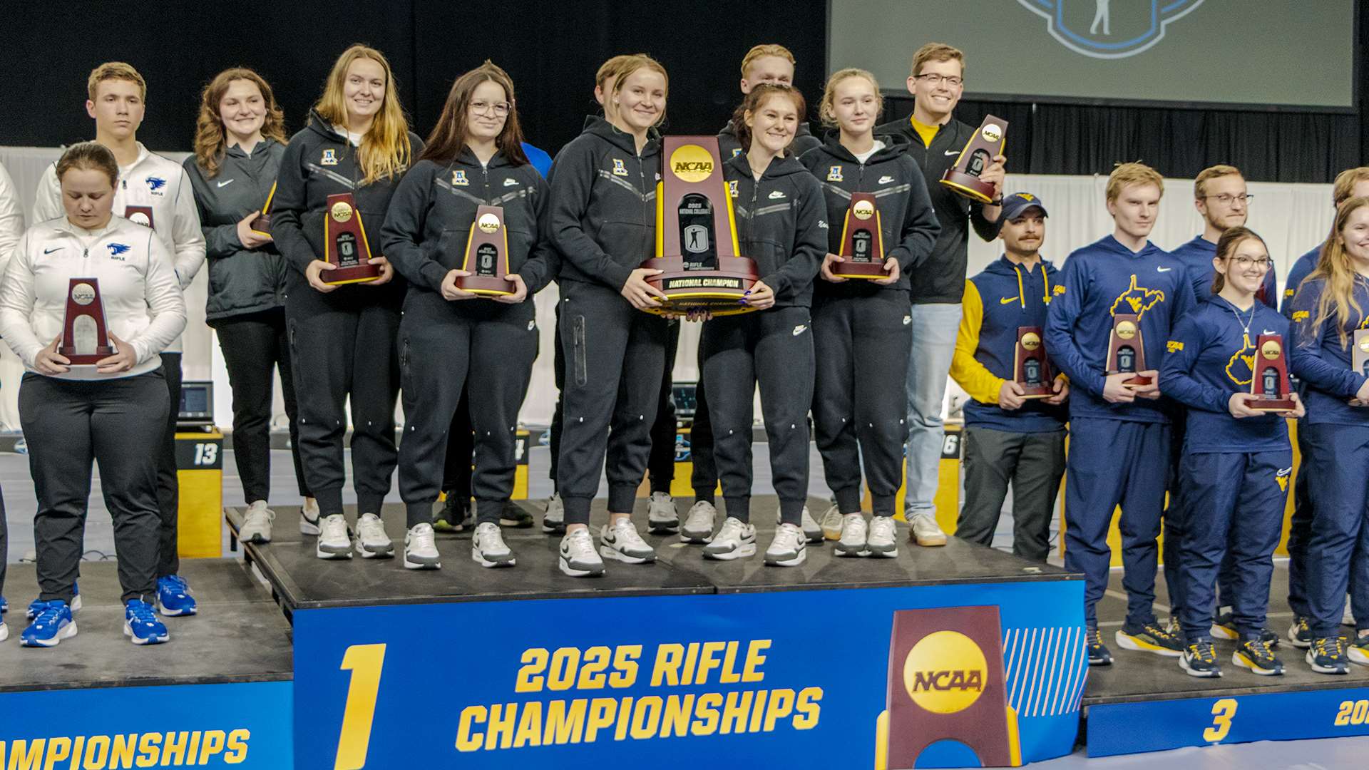 University of Alaska-Fairbanks rifle team on the awards podium after winning the 2025 NCAA smallbore team championship at Memorial Coliseum Lexington Kentucky