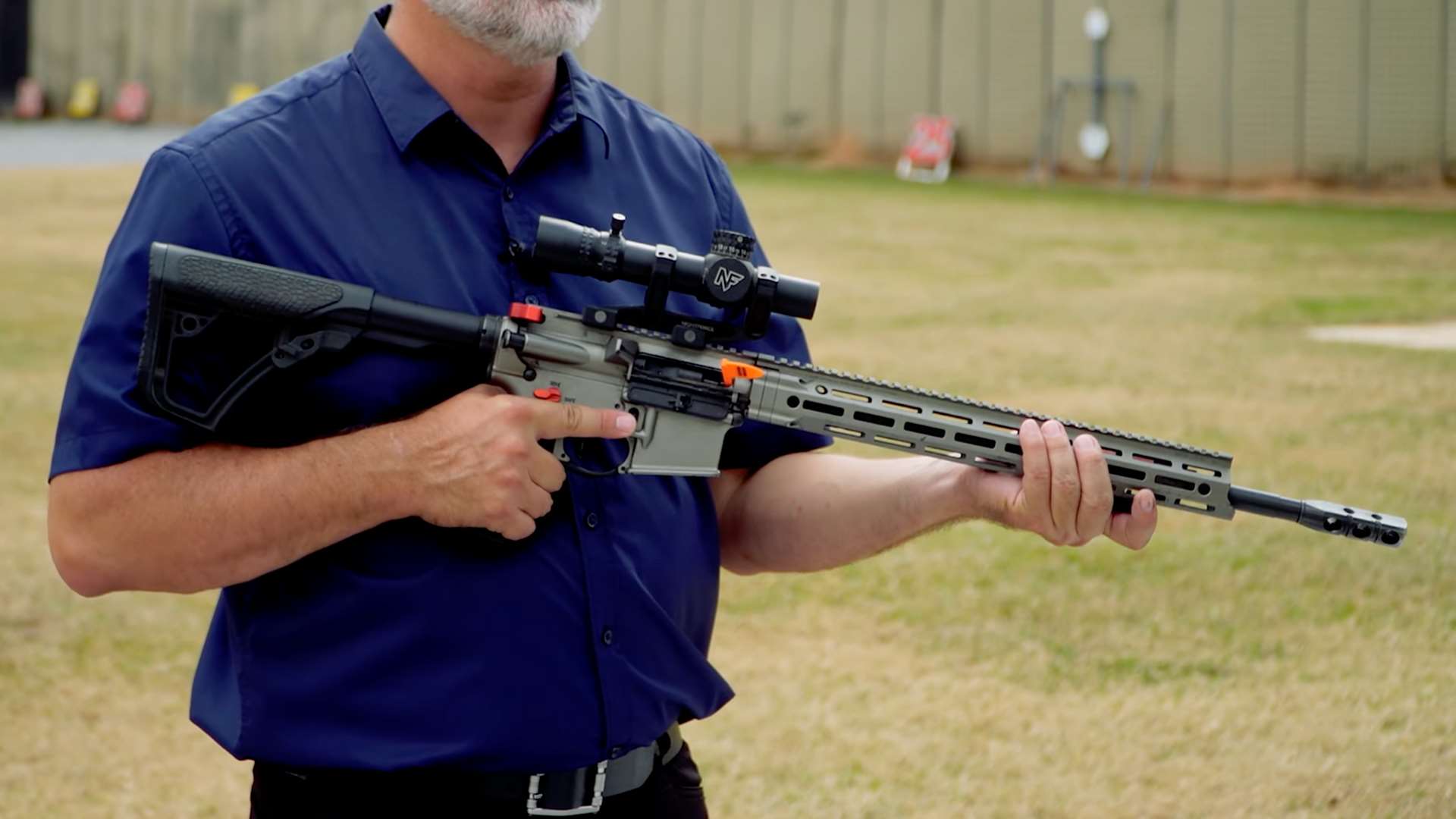 Ryan Muller holding an AR-15 configured for NRA America’s Rifle Challenge Limited division with magnified optic