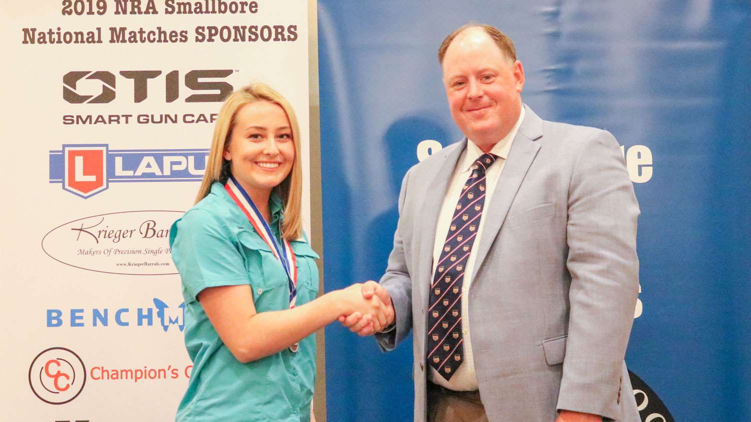 Zinsmeyer receives an award from NRA Competitive Shooting Director Cole McCulloch.