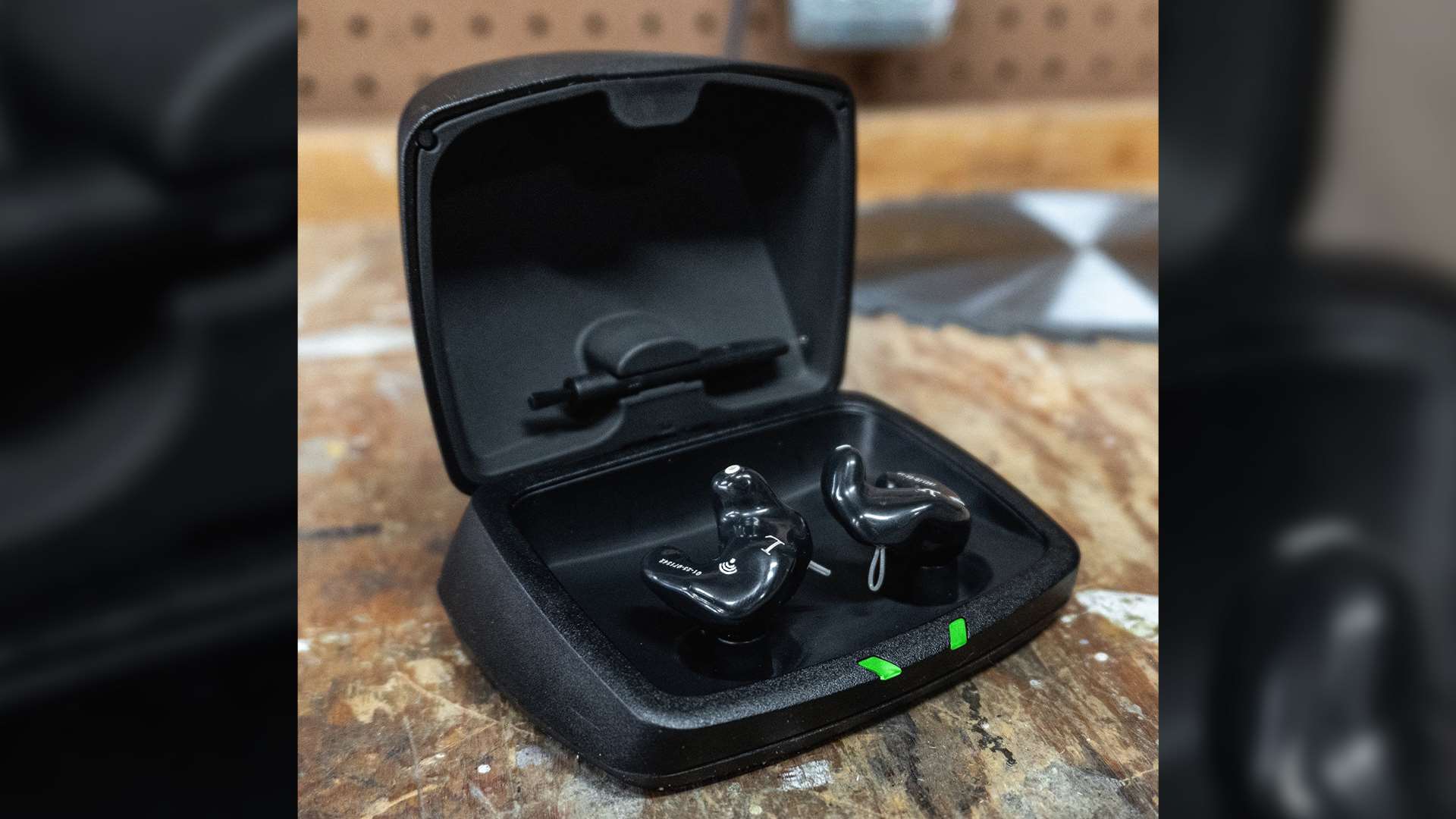 A pair of SoundGear Phantom custom electronic earplugs in black faceplate and black shell configuration