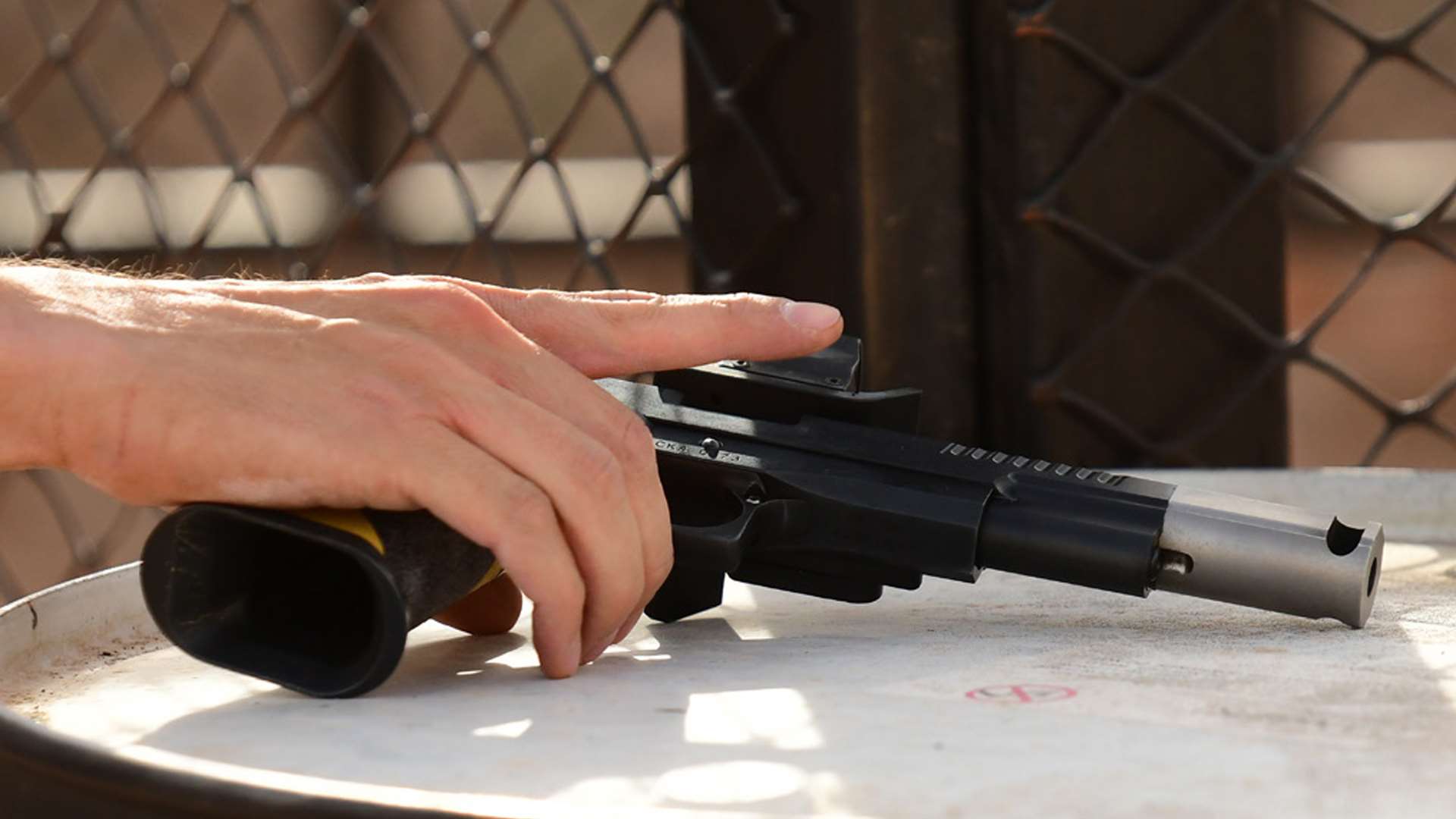 pistol resting on a barrel