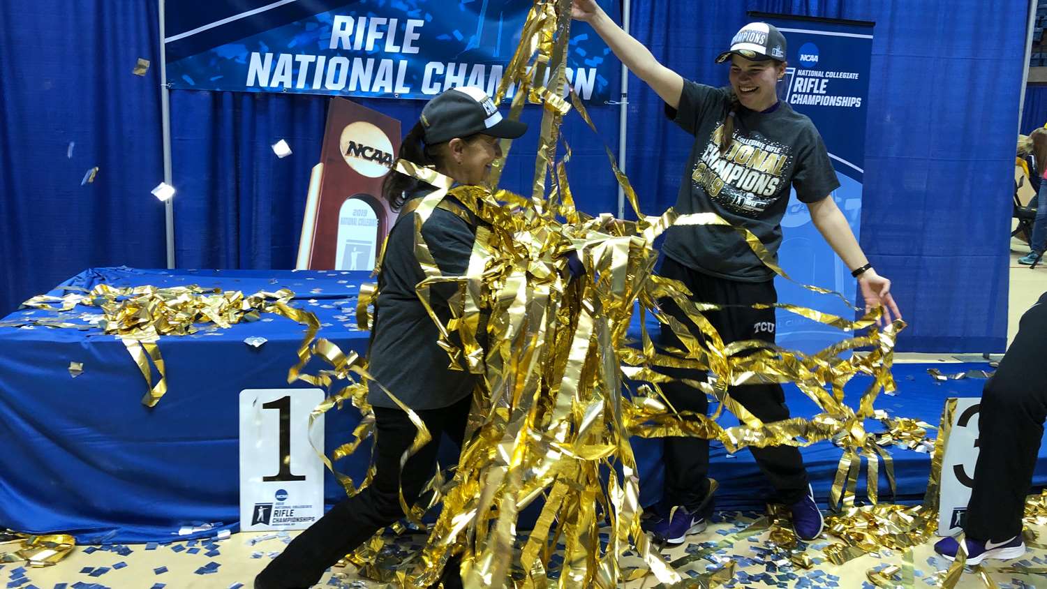 TCU Rifle Coach Karen Monez receives shower of gold ribbon