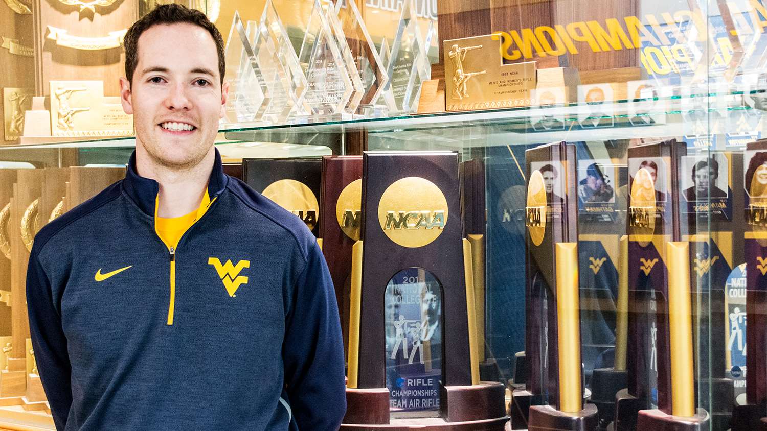 WVU Rifle Coach Jon Hammond and trophy case