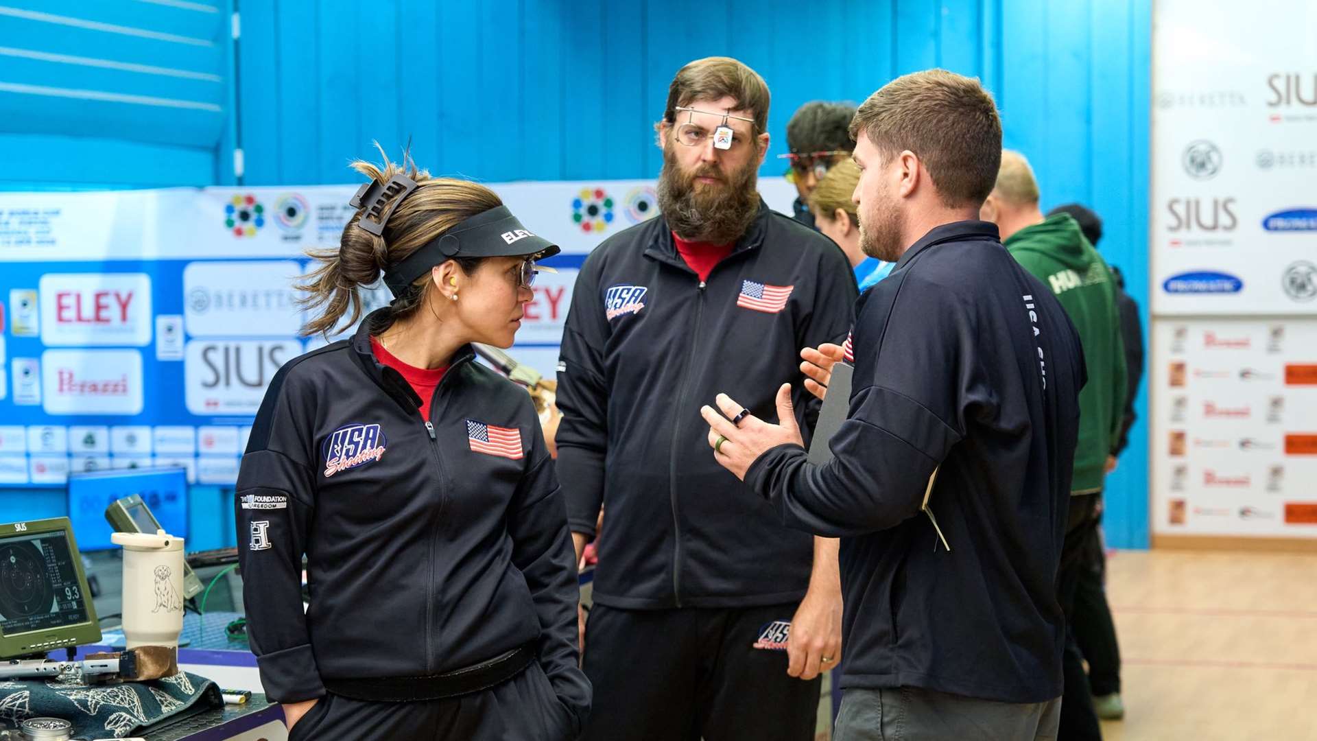 Nathalia Tobar and Nick Mowrer standing together between rounds at the 10m air pistol mixed team event in Granada, Spain