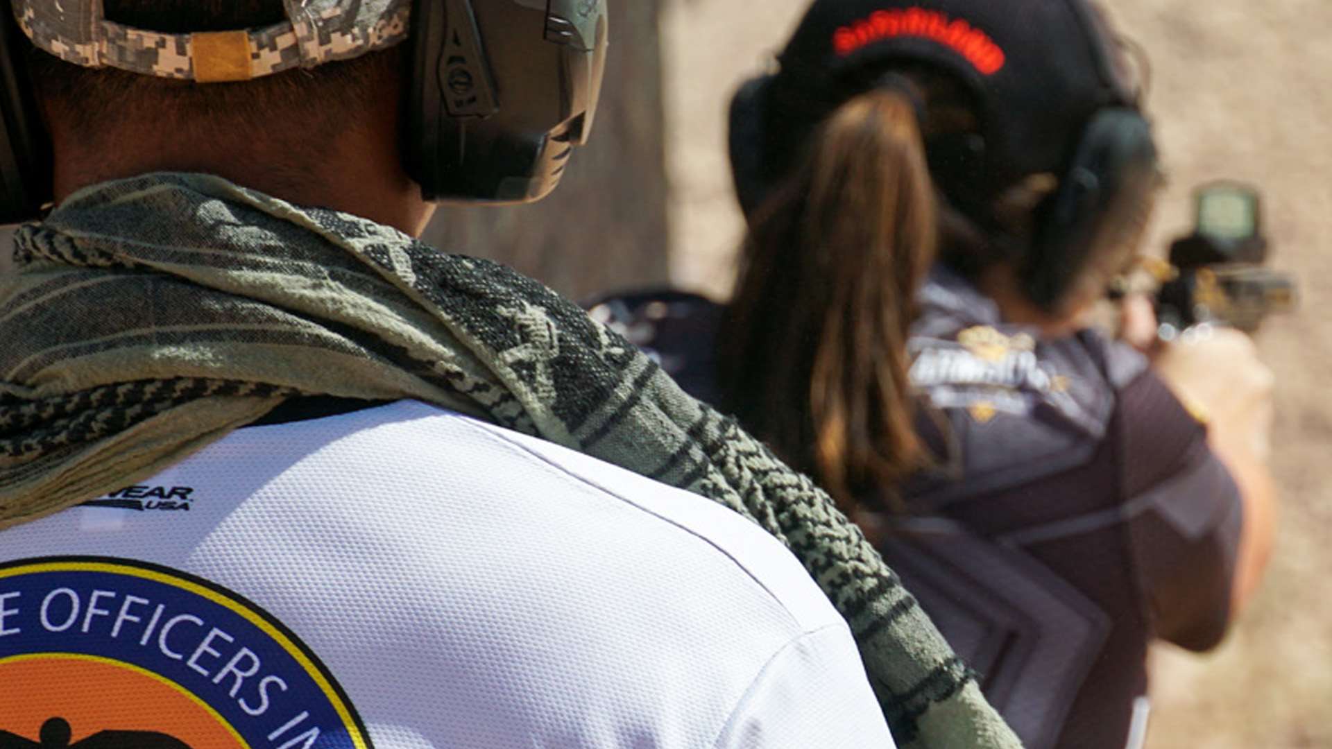USPSA Range Officer watches a competitor shooting a pistol