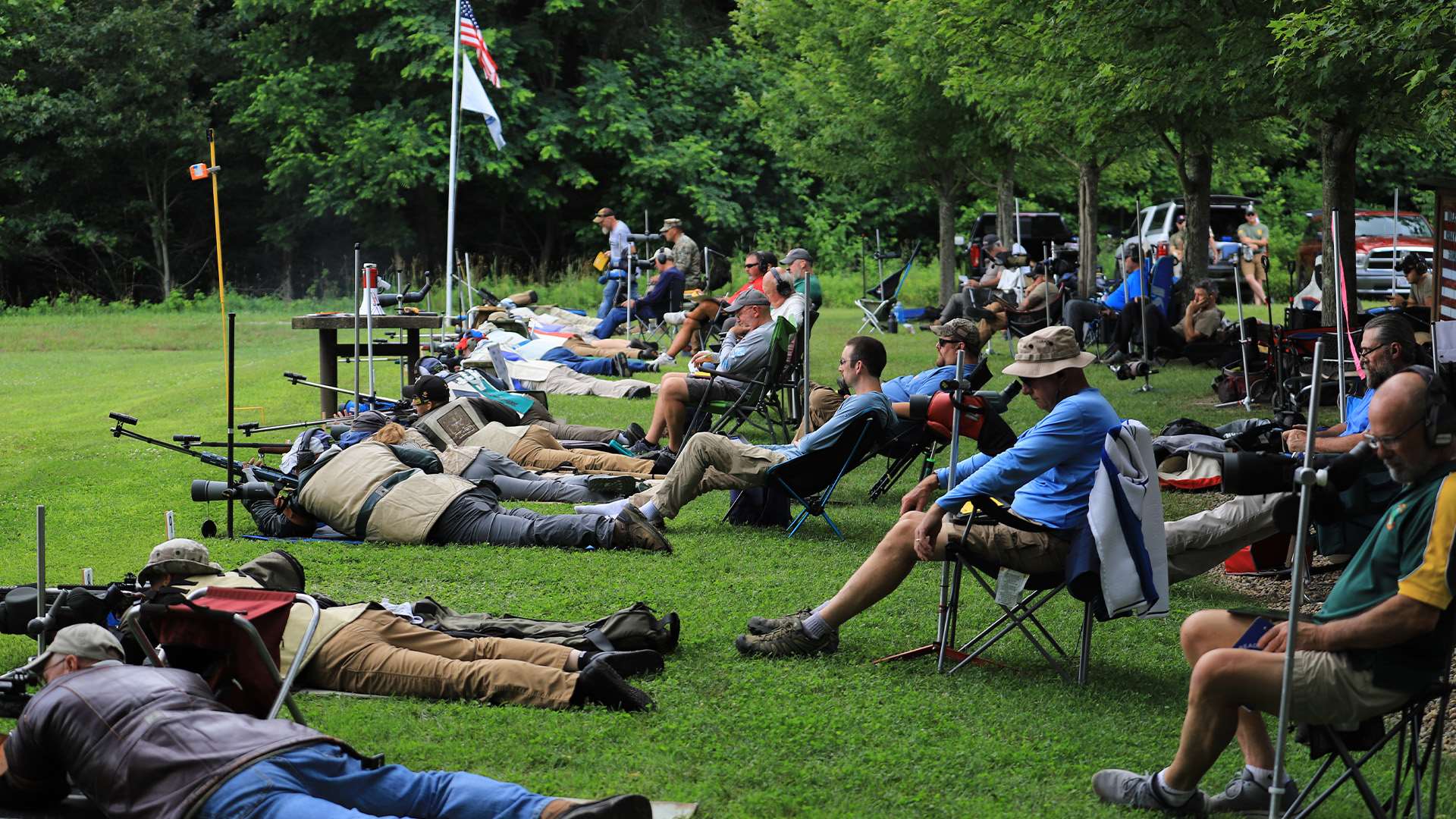 Rows of prone rifle competitors on the 1,000-yard firing line at Alliance Rifle Club under open sky
