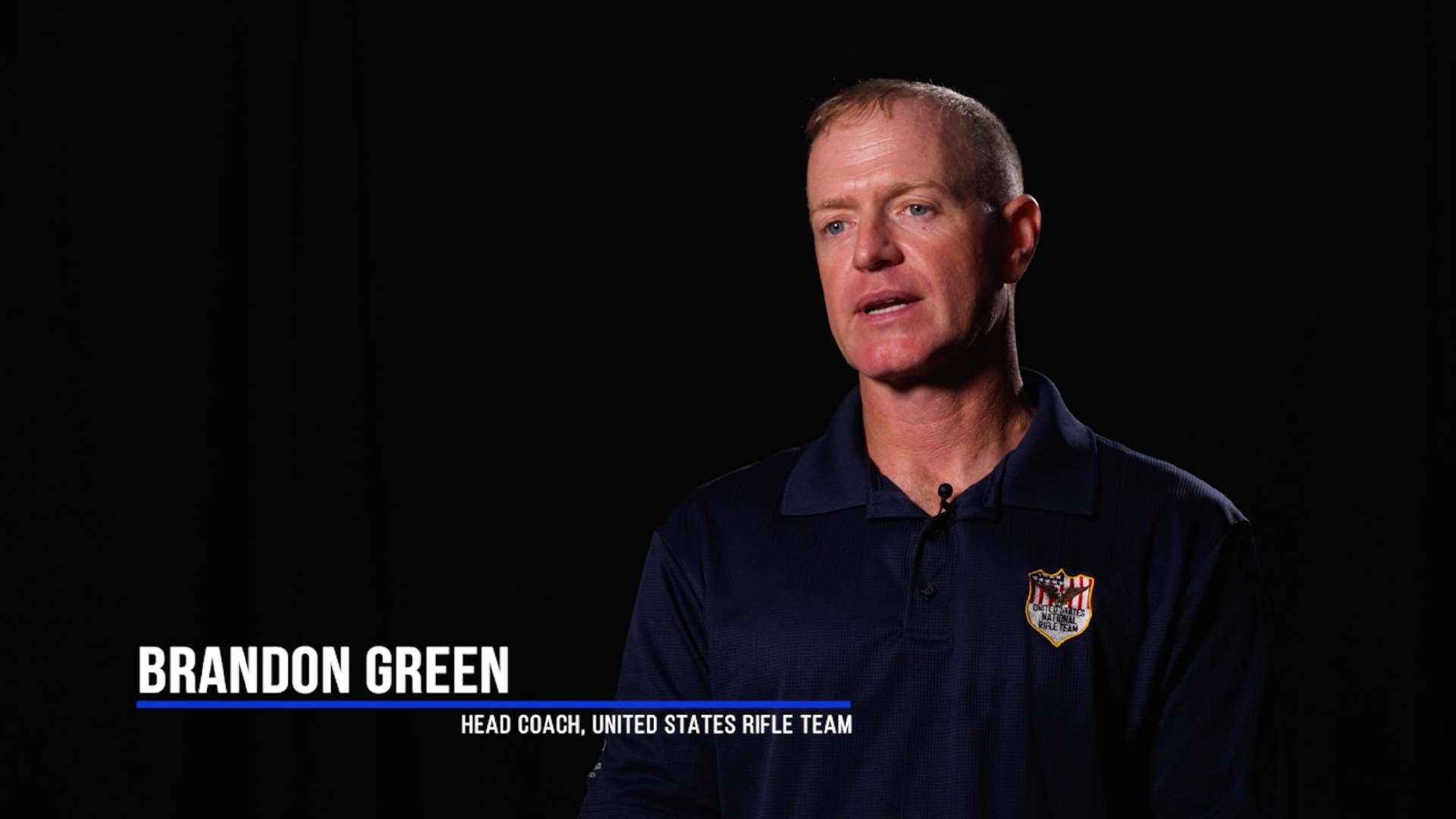 Brandon Green filmed in a video talking about the US National Rifle Team and how to support the program