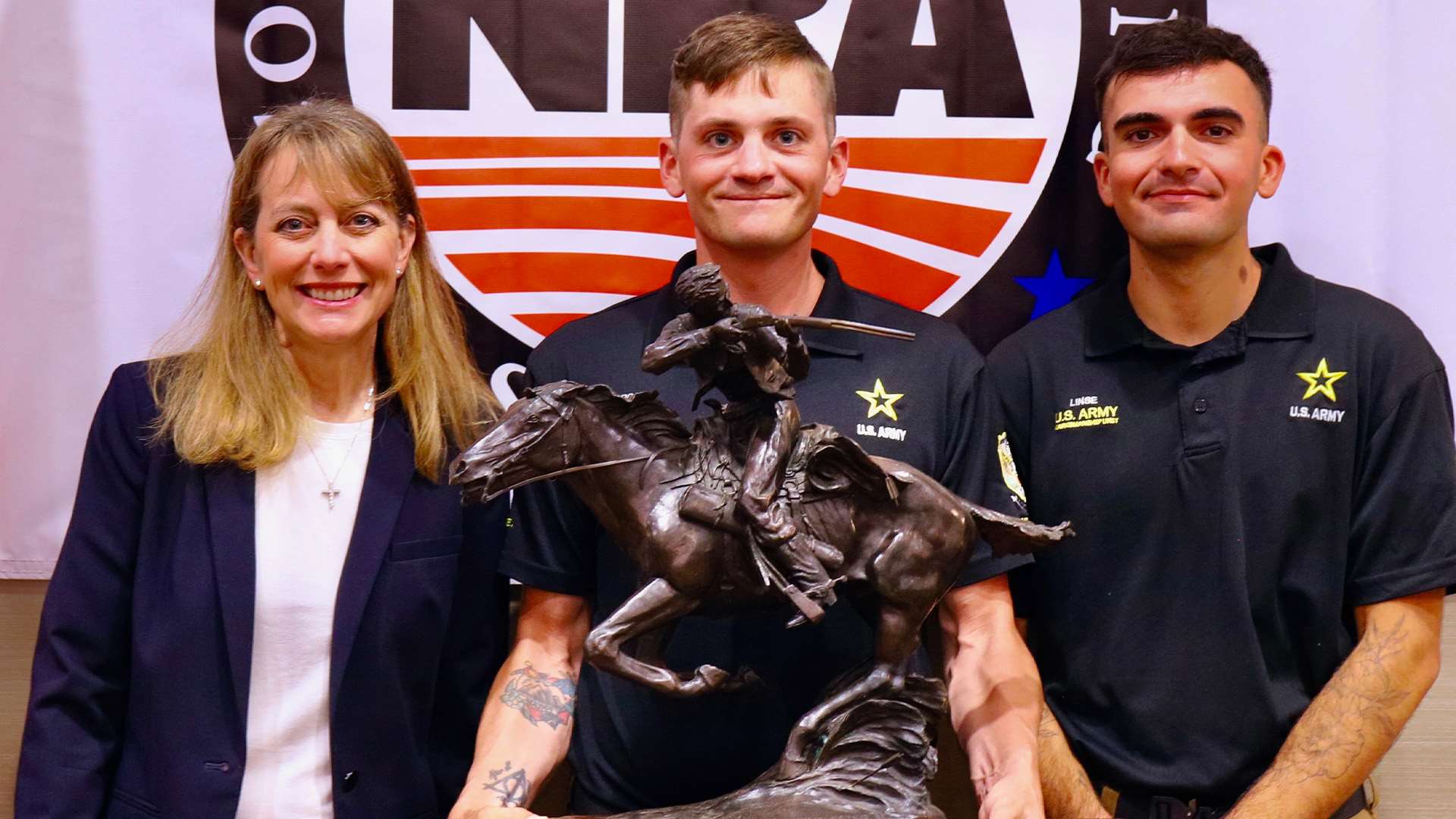 Kim Rowe, Logan Frost and Zevin Linse on the Tompkins Trophy podium at the Long-Range Championship awards ceremony
