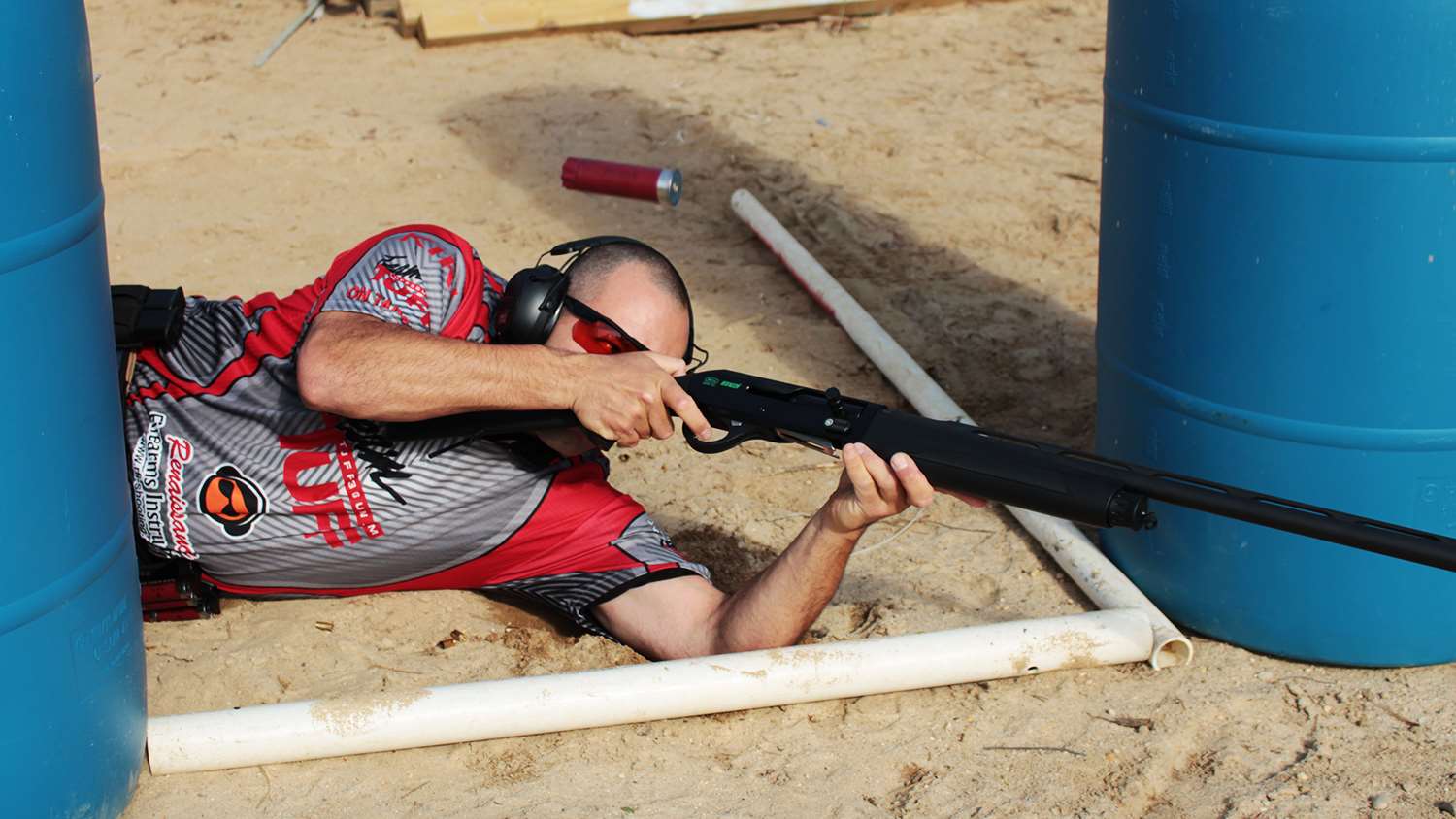 3-Gun Shotgun Drills | Get creative during practice. Matches are shot from a variety of positions, be sure to challenge yourself before the stage does! Here the left-handed author practices his weak side shooting from the ground. Obstacles and fault lines may force this maneuver in a match