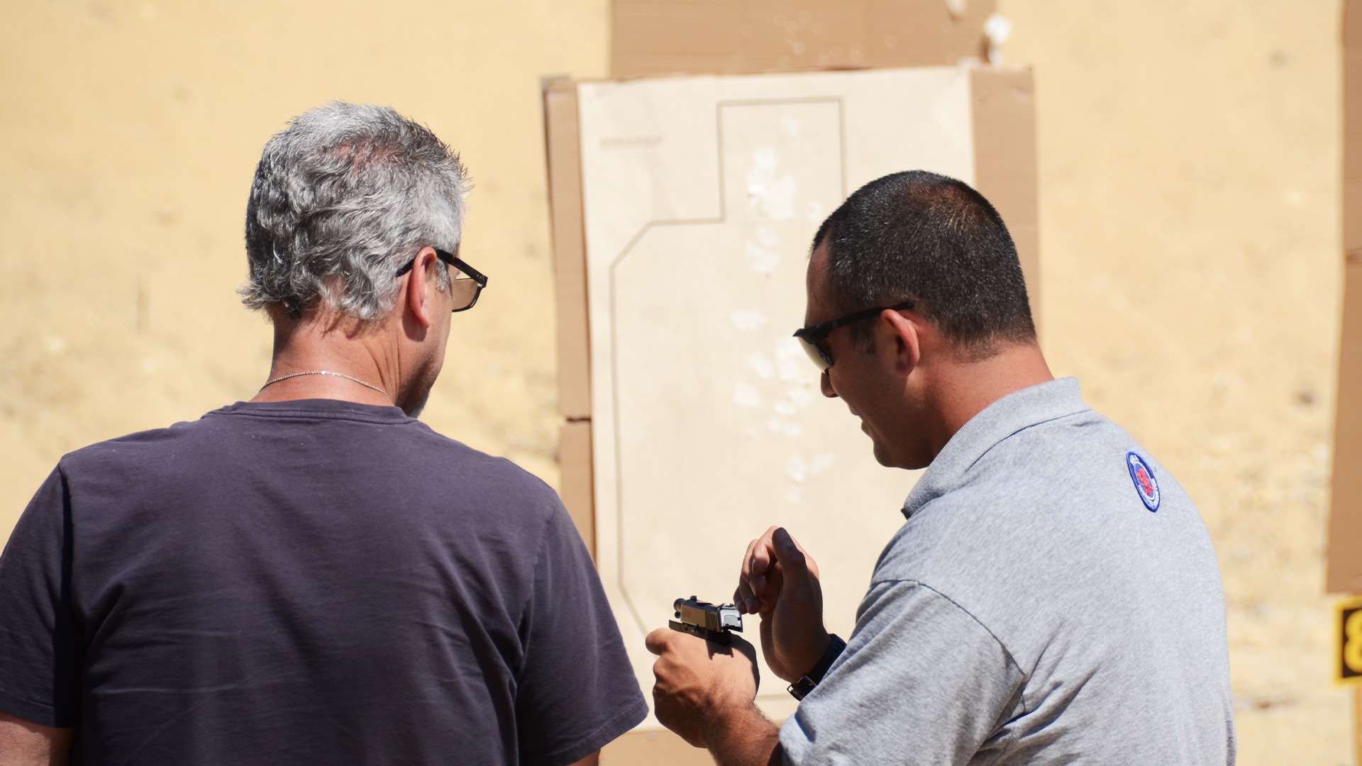 Frank Melloni instructs a pistol student