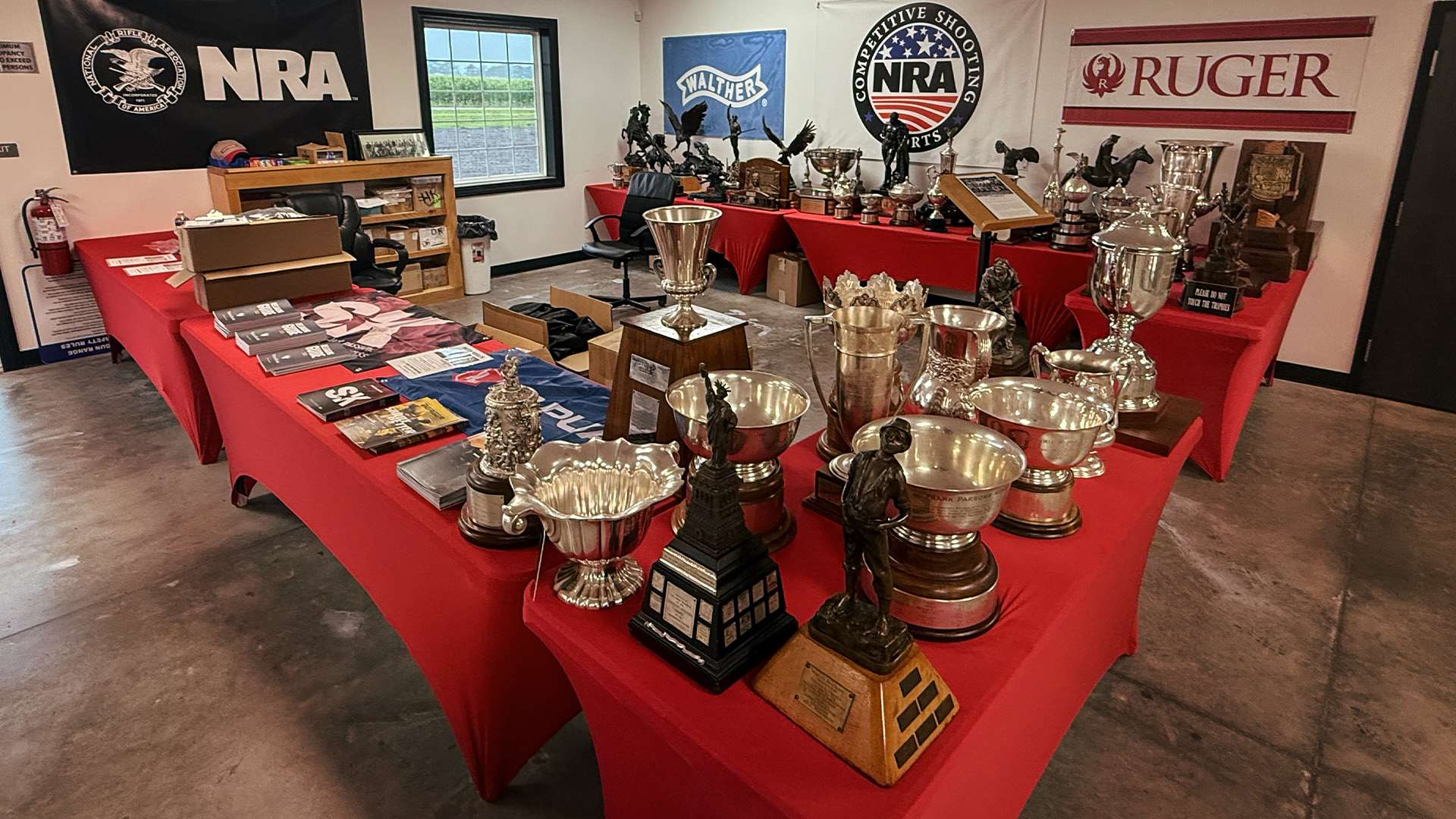 Engraved silver trophies from the historic NRA Trophy Collection on display at the Cardinal Shooting Center