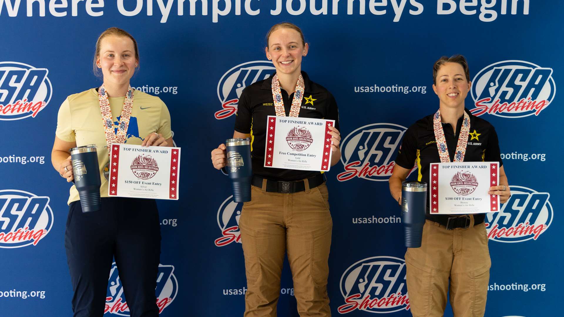 Three female shooters hold Top Finisher Award certificates in front of a USA Shooting backdrop at the 2026 Rifle Fall Selection Match