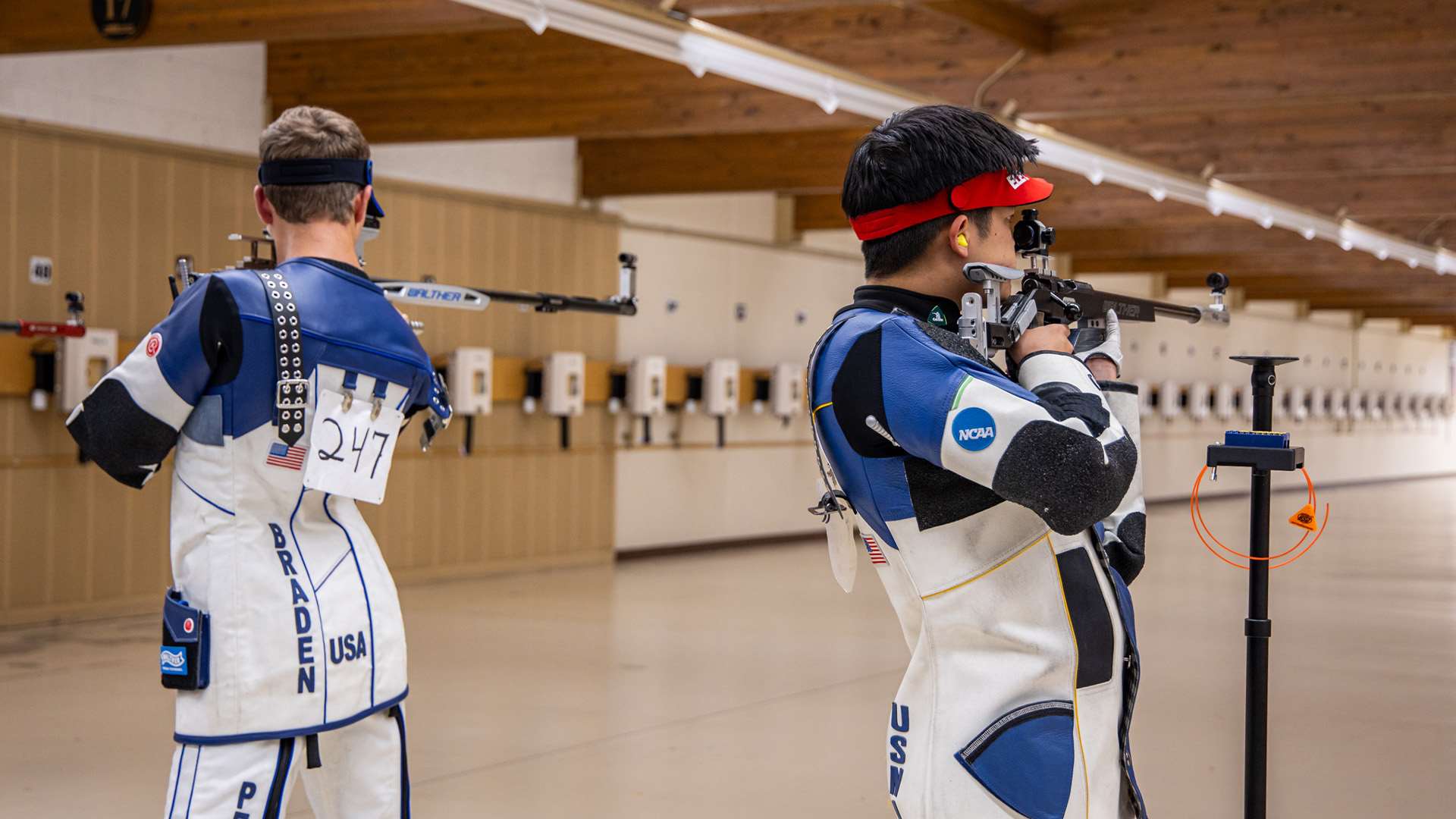 Two male smallbore competitors shoot from the standing position at adjacent firing points during the 50m rifle 3-position final at the 2026 Rifle Fall Selection Match