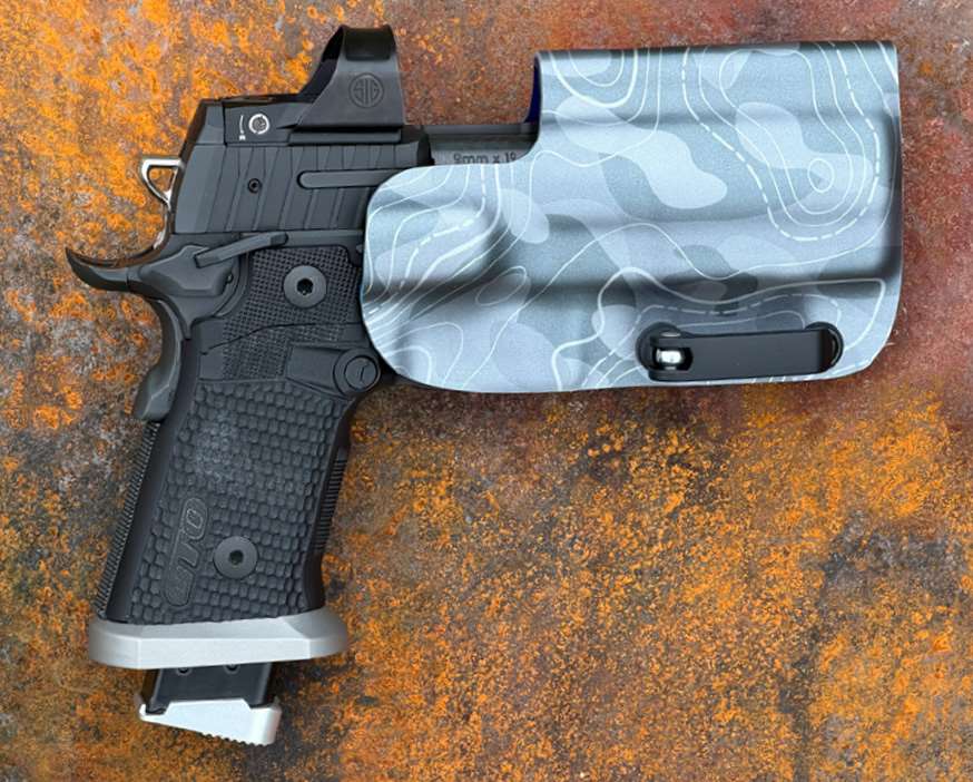 SIG Sauer P211-GTO handgun in a holster on a table