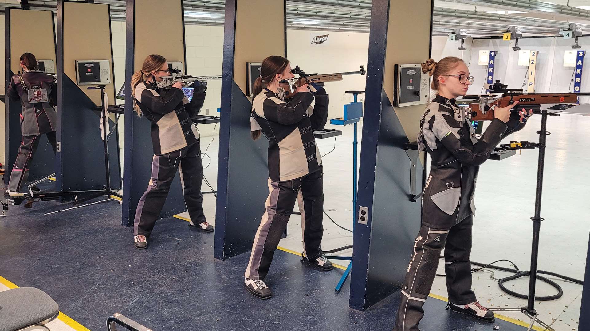 Molly Miller and Mount Aloysius College rifle team at Akron home range for NCAA qualifier match