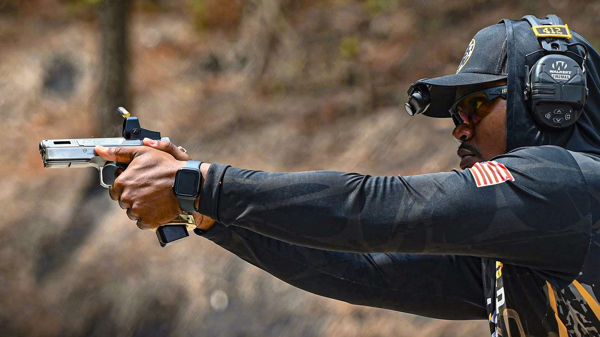 Deshaun Jenkins engages a target during a USPSA stage