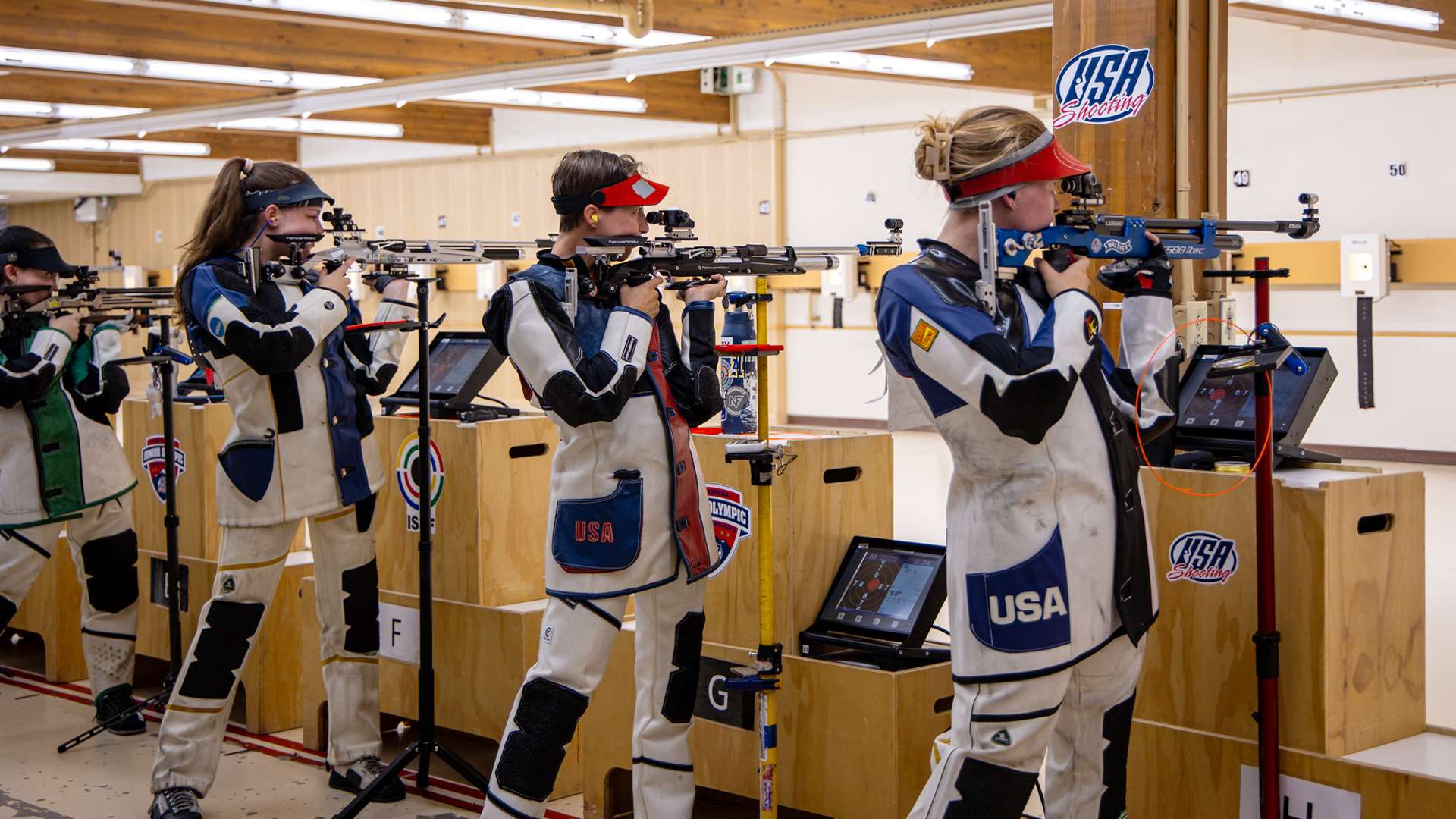 Four female air rifle shooters in standing position on the firing line during qualification at the 2026 Rifle Fall Selection Match