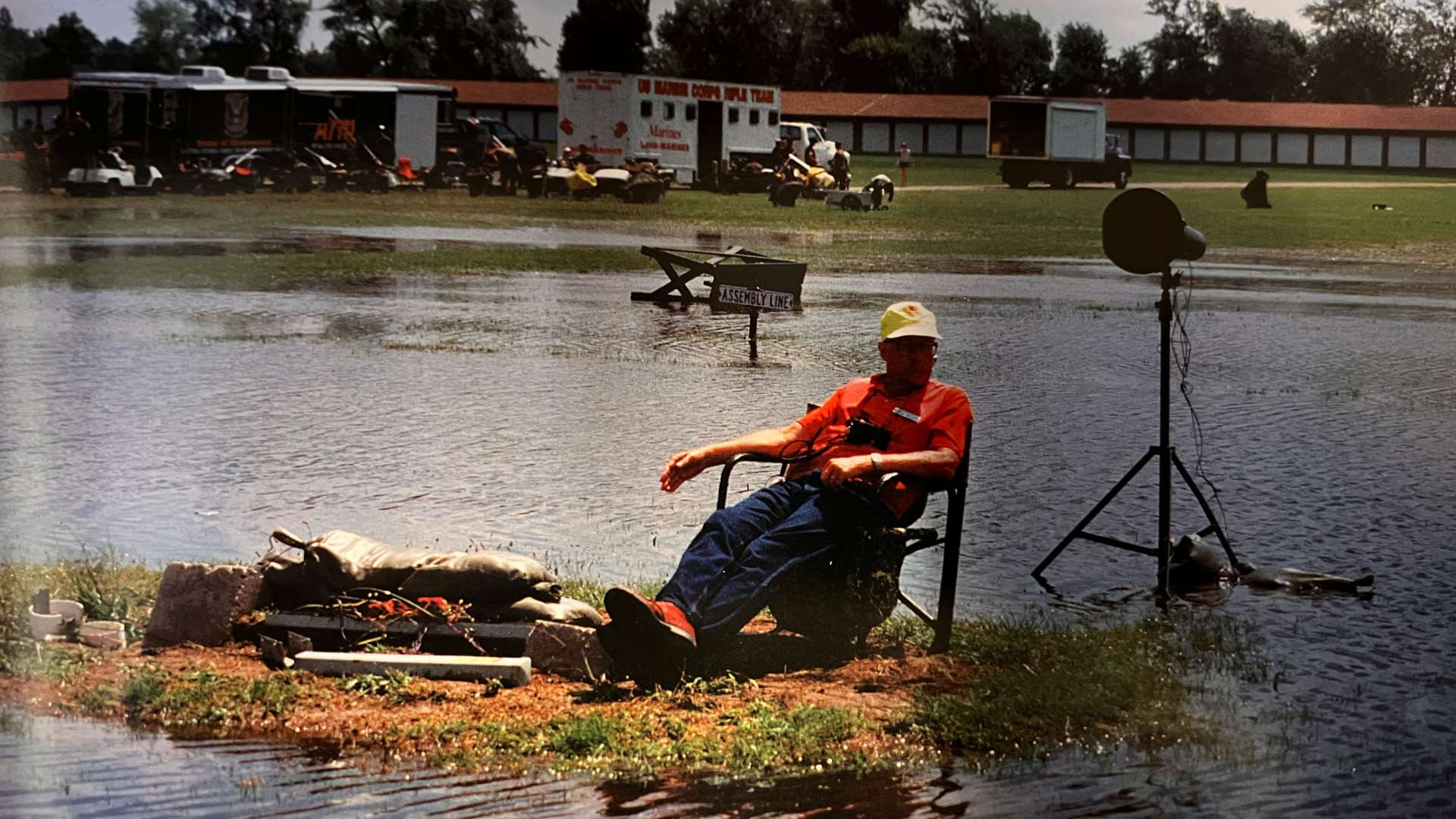"Damp Perry" in 2000 during the National Matches. A man sits in a chair surrounded by water