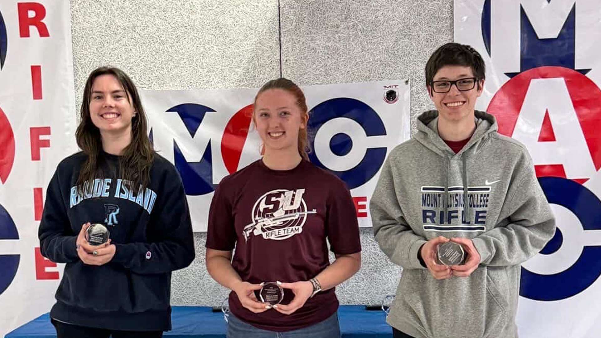The top three smallbore finishers at the 2026 Mid-Atlantic Rifle Conference Championship at MIT stand on the podium