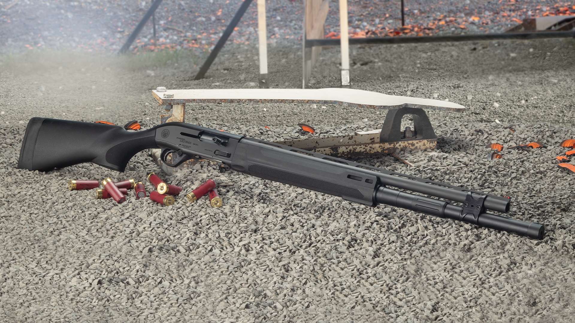 Beretta A300 Ultima Competition 12-gauge semi-auto shotgun for multigun competition on gravel with spent shells and steel in the background