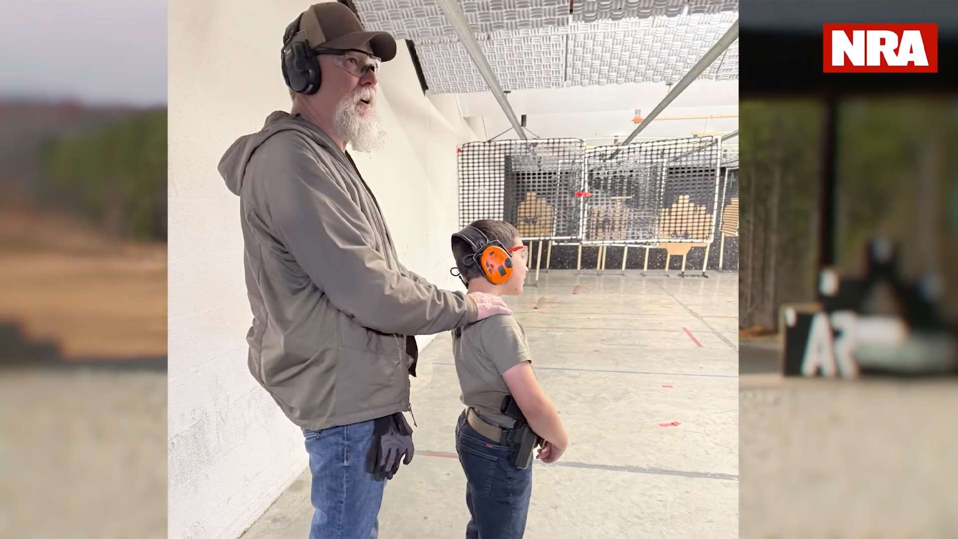 Kyle Lamb with his grandson Denver at a shooting range, illustrating the family-friendly nature of NRA America's Rifle Challenge competition