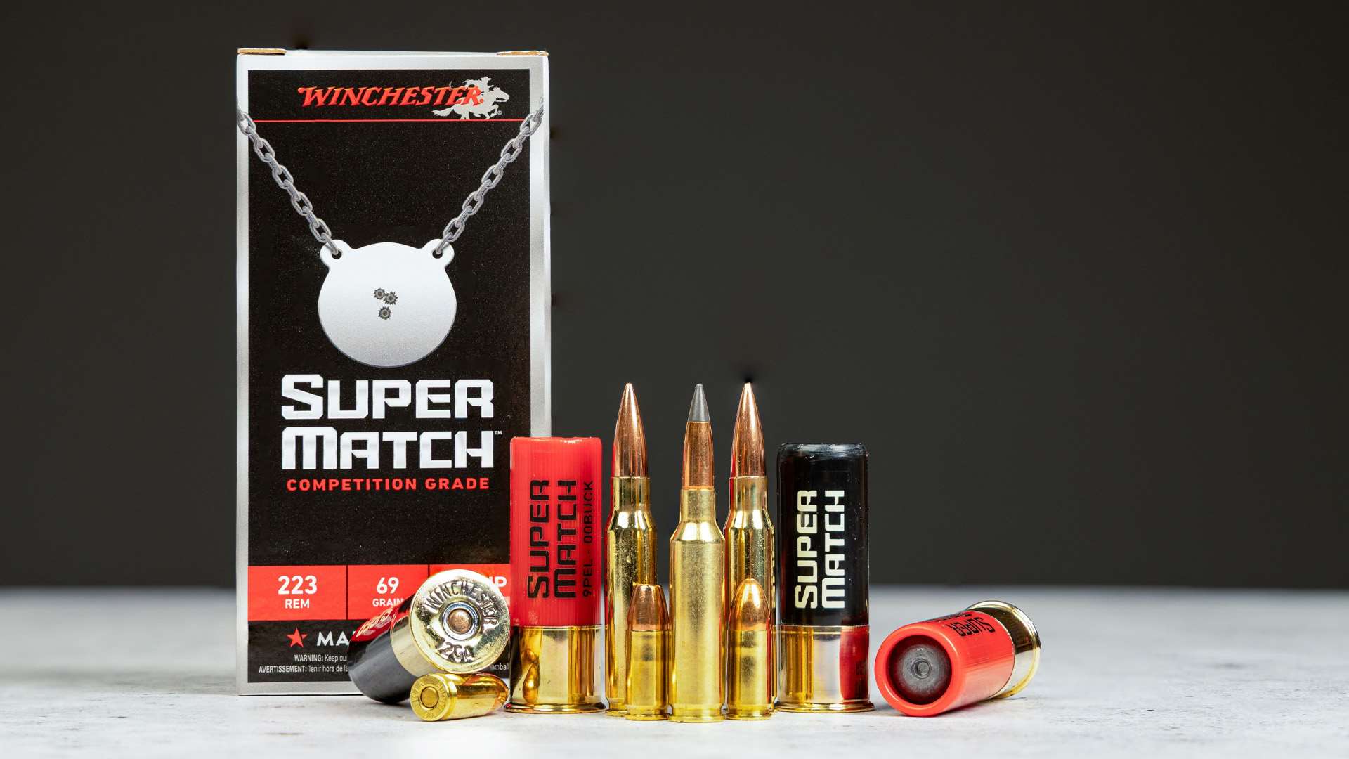 Winchester Super Match .223 Rem. 69-grain box beside rifle cartridges, pistol rounds and 12-gauge shotshells
