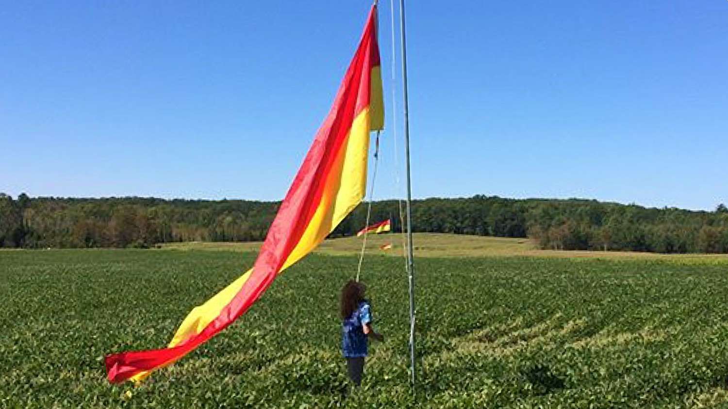 Sydnie next to a range flag