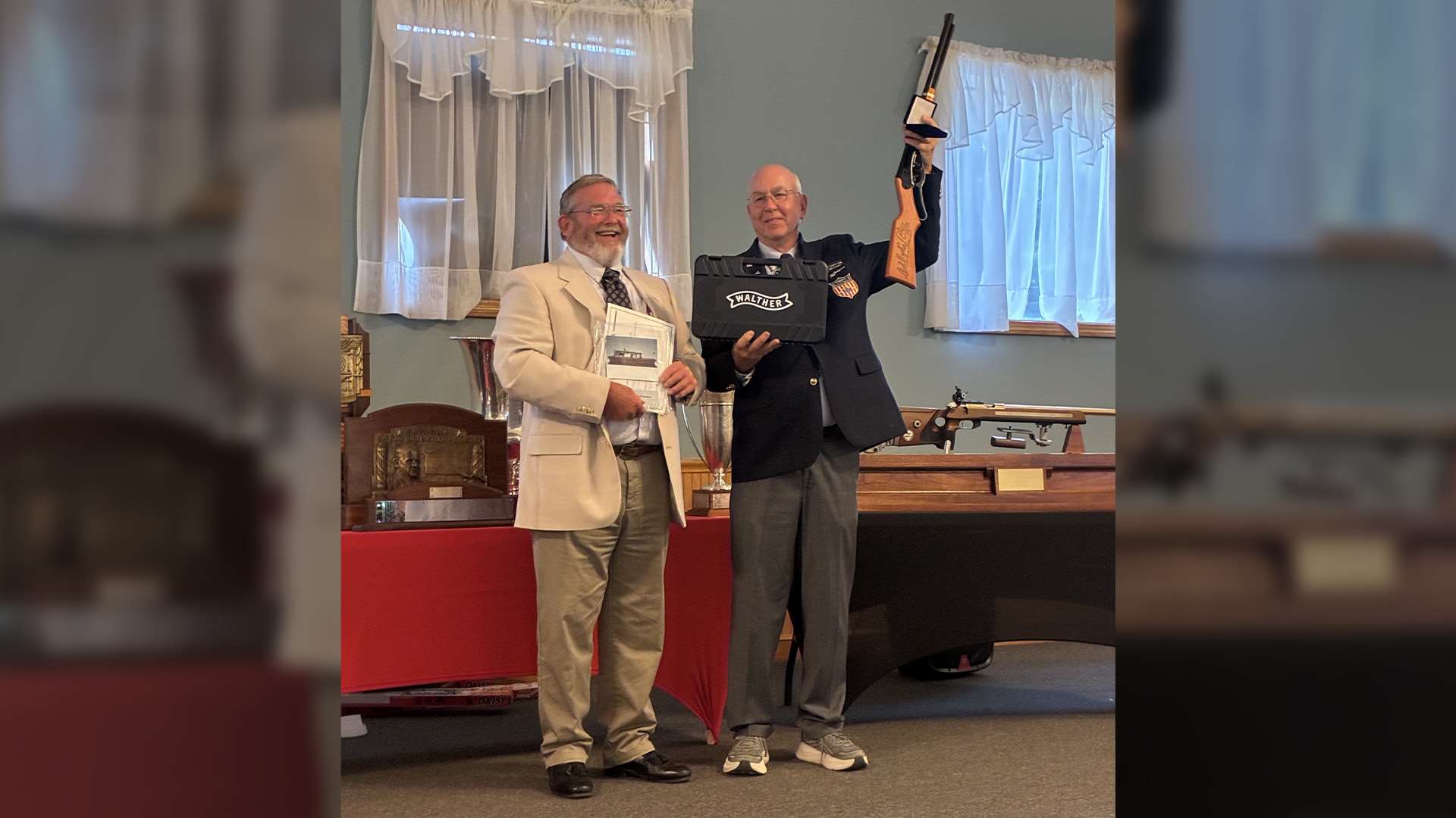 Clyde Furr hands the NRA Lones Wigger Iron Man Trophy to Mike O'Connor at the awards ceremony