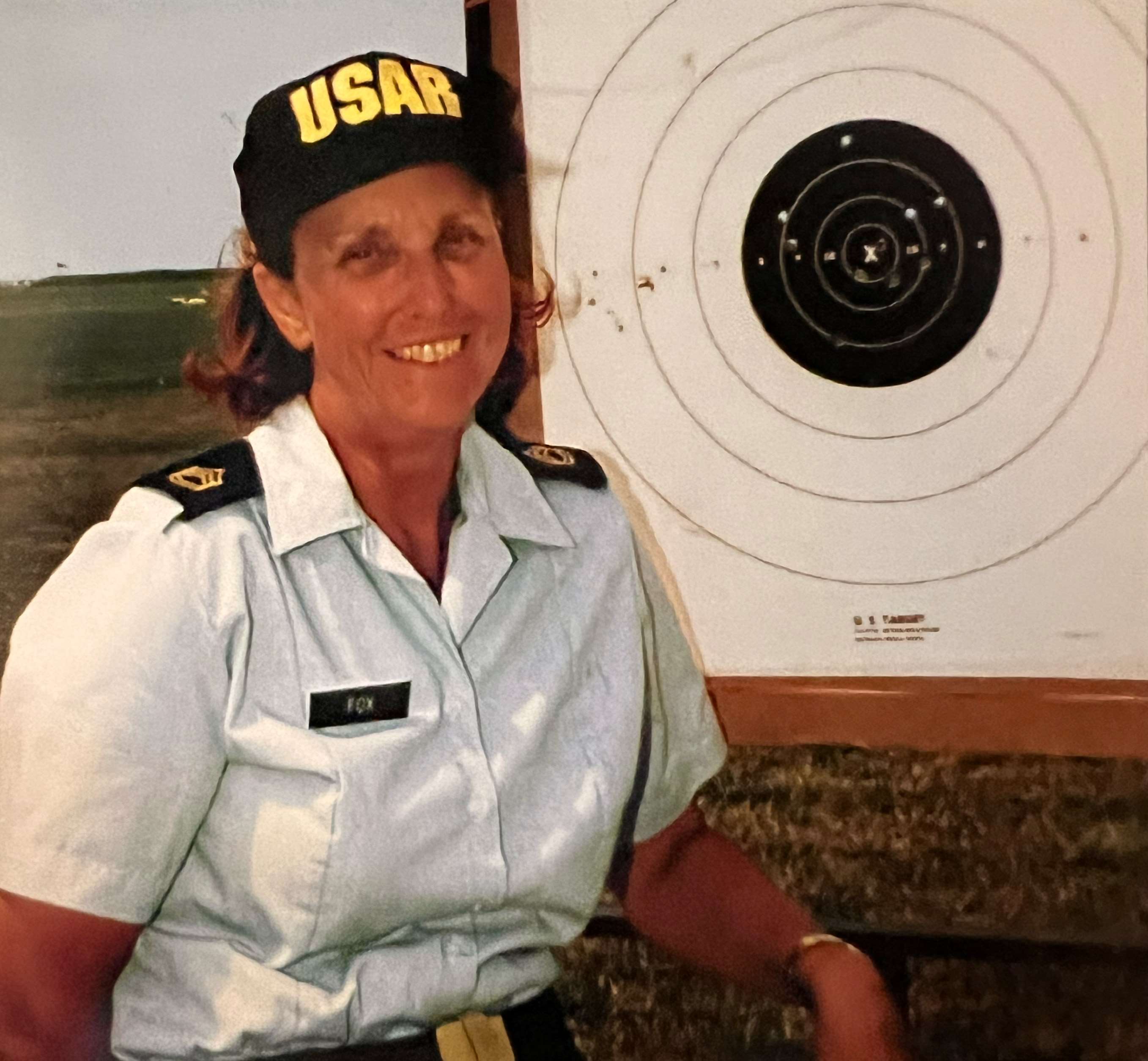 Ruby Fox at Camp Perry with a target and a USAR hat