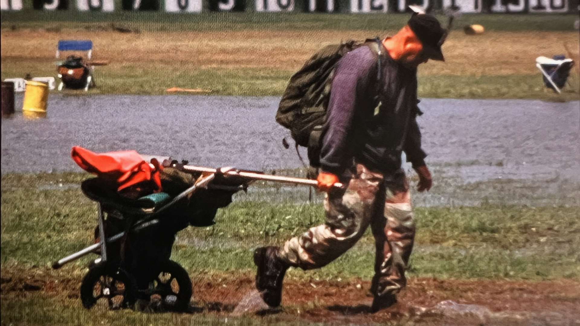 Army competitive shooter hauls gear across a wet range at Camp Perry in 2000