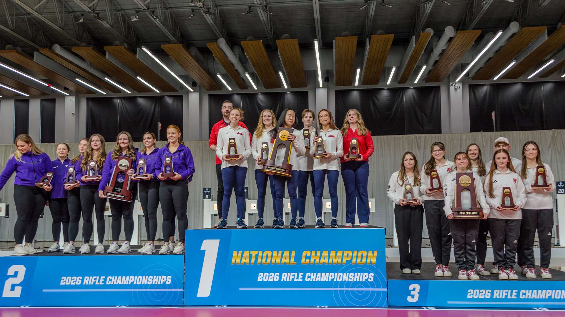 Ole Miss rifle team celebrates on the center podium position after winning the smallbore team championship at the 2026 NCAA Rifle Championship at Ohio State's Covelli Center
