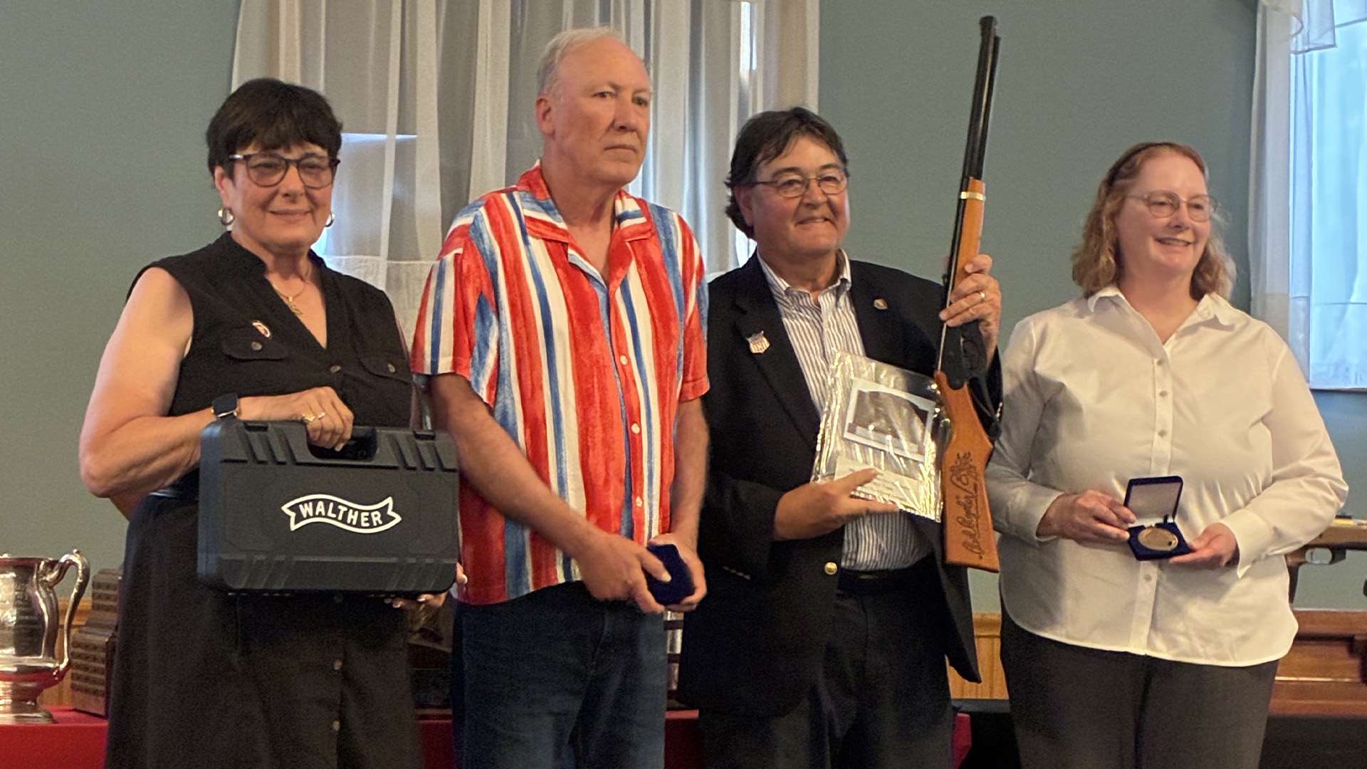 NRA Smallbore Committee Chair Patti Clark with Conventional Prone podium finishers Ron Wigger, Mike Carter and Michelle Bohren