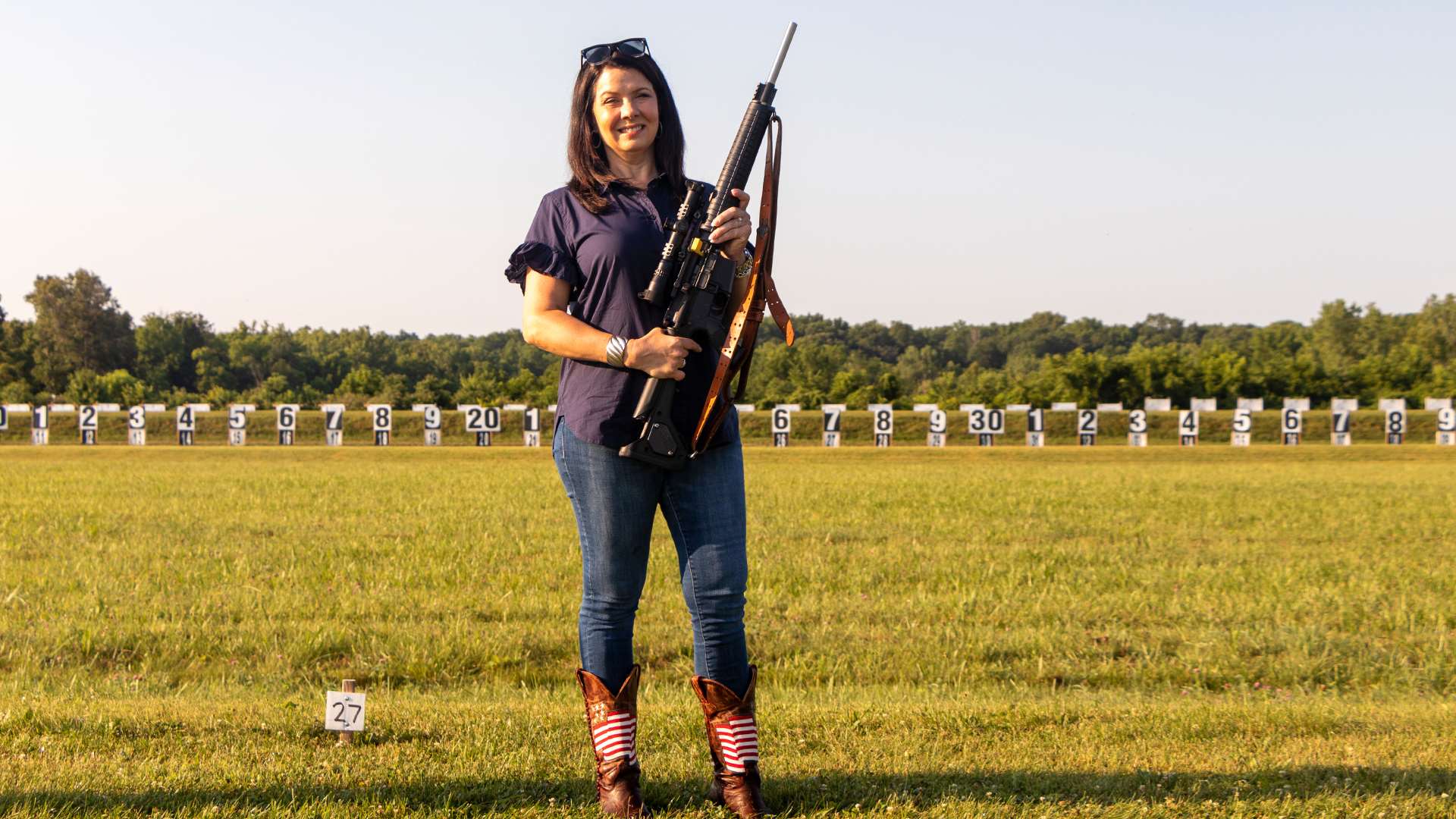 Janet Holcomb holding an AR15 rifle