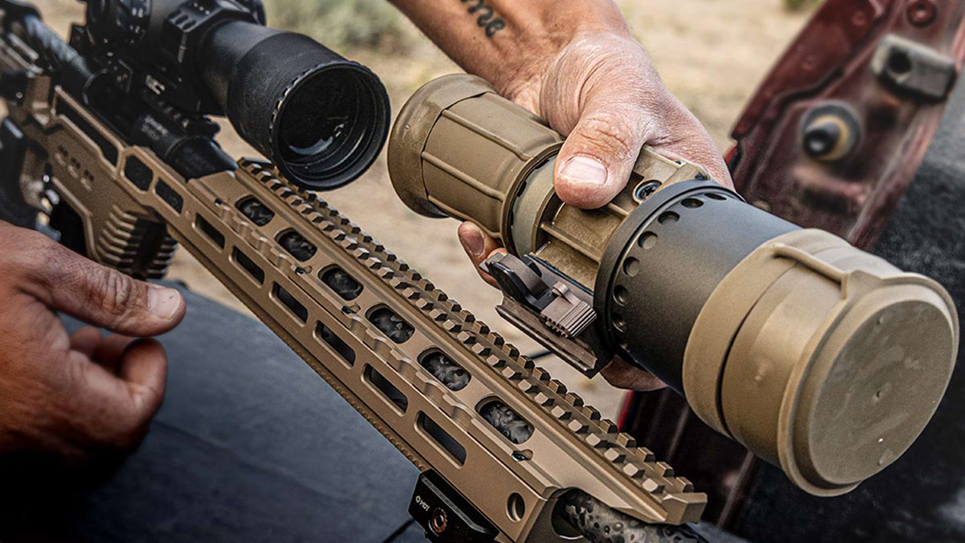 Two hands placing a tan clip-on night optic onto the rail of a flat dark earth MDT One-Piece NV Bridge in front of a riflescope, with promotional text reading "New One-Piece NV Bridge 20 MOA"