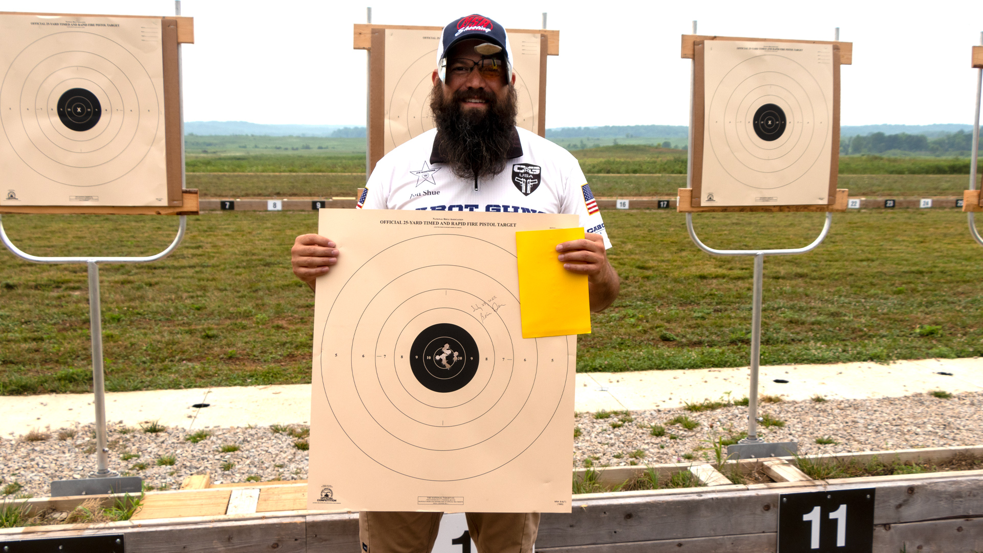 Jon Shue with bullseye pistol target