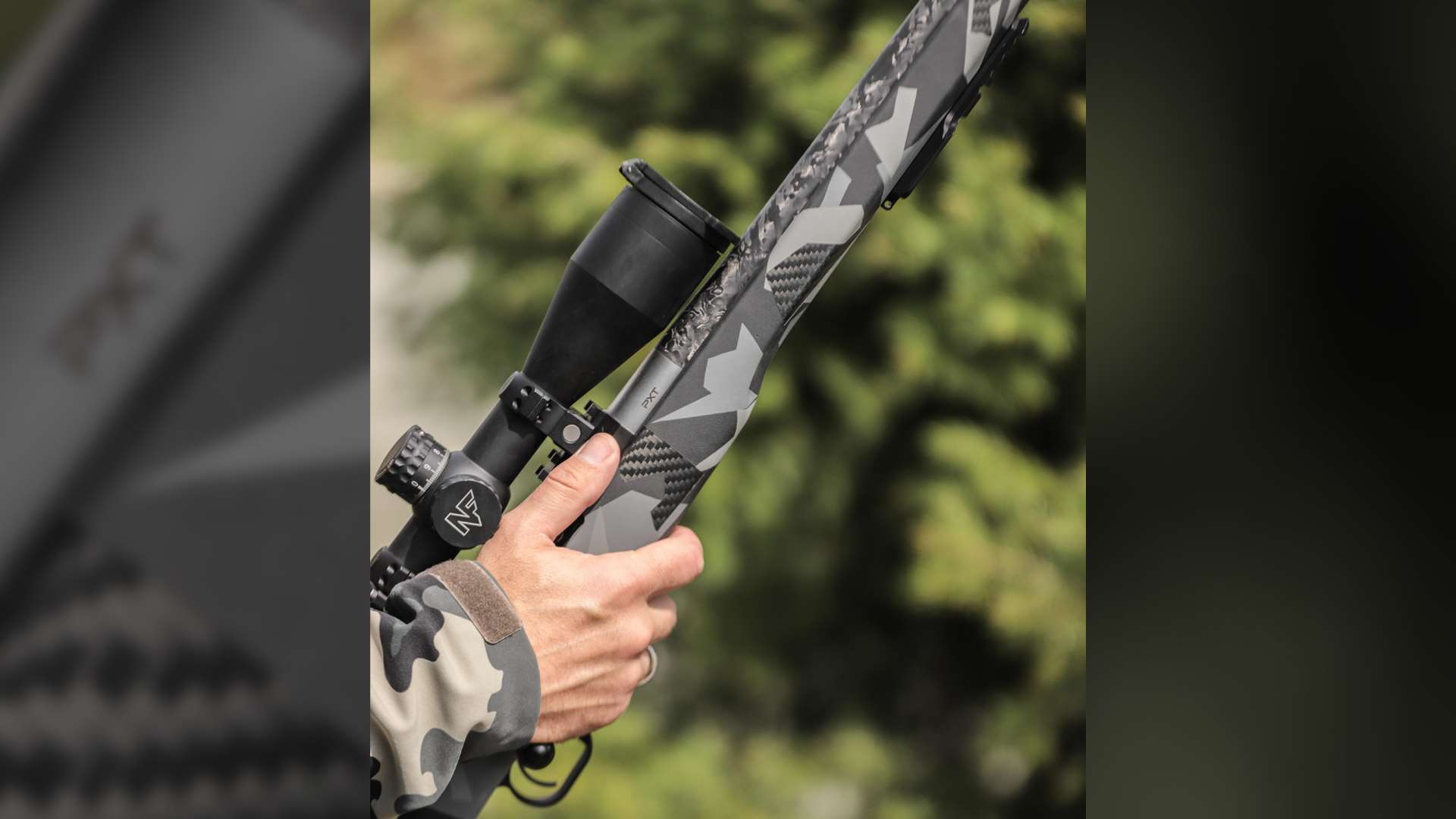 Close-up photograph of a shooter with a PROOF Research Elevation FDX rifle with grey camouflage stock and mounted Nightforce optic, photographed outdoors with green foliage in the background